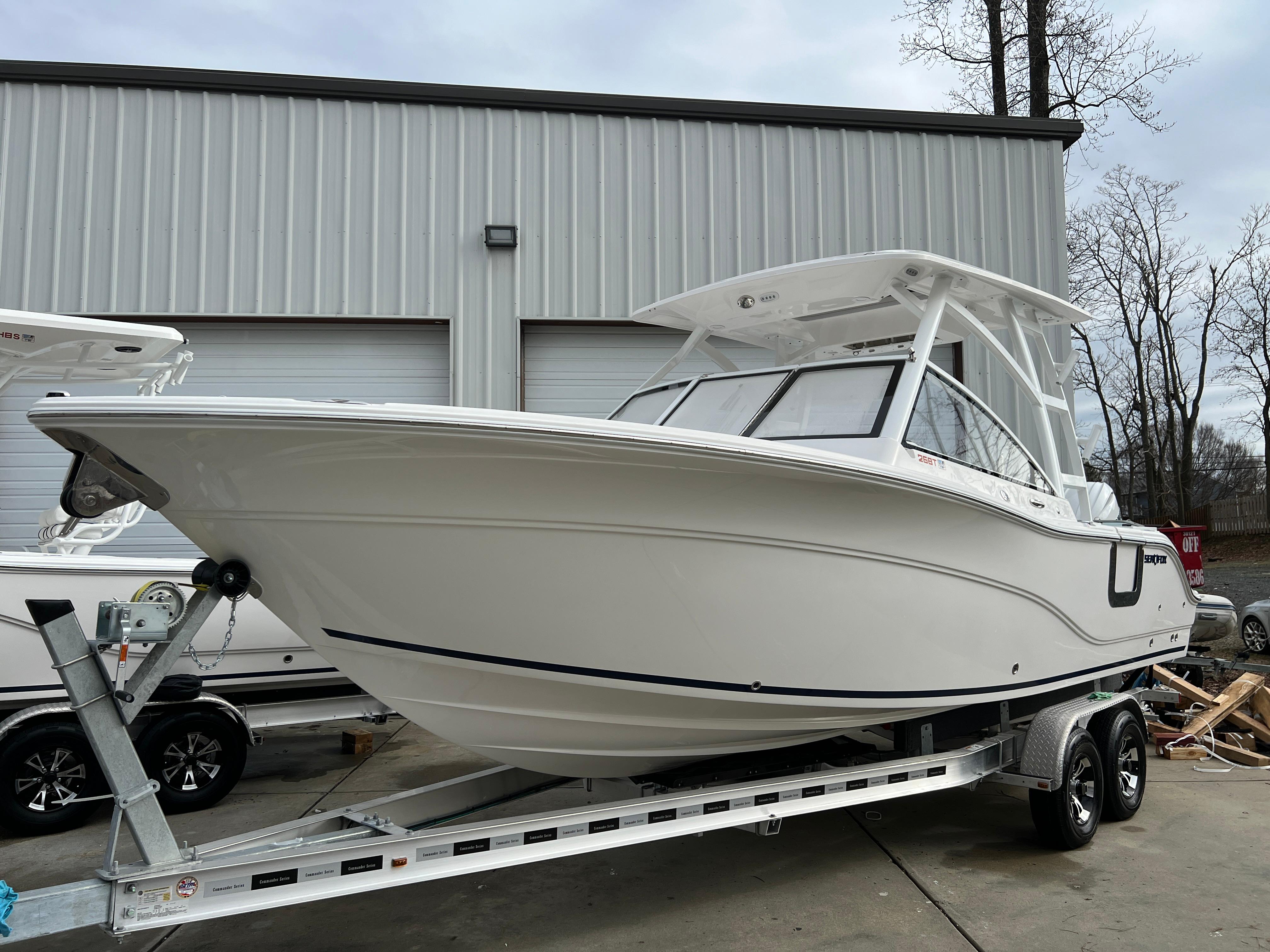 2024 Sea Fox 268 Traveler boat on trailer, parked outside a warehouse.