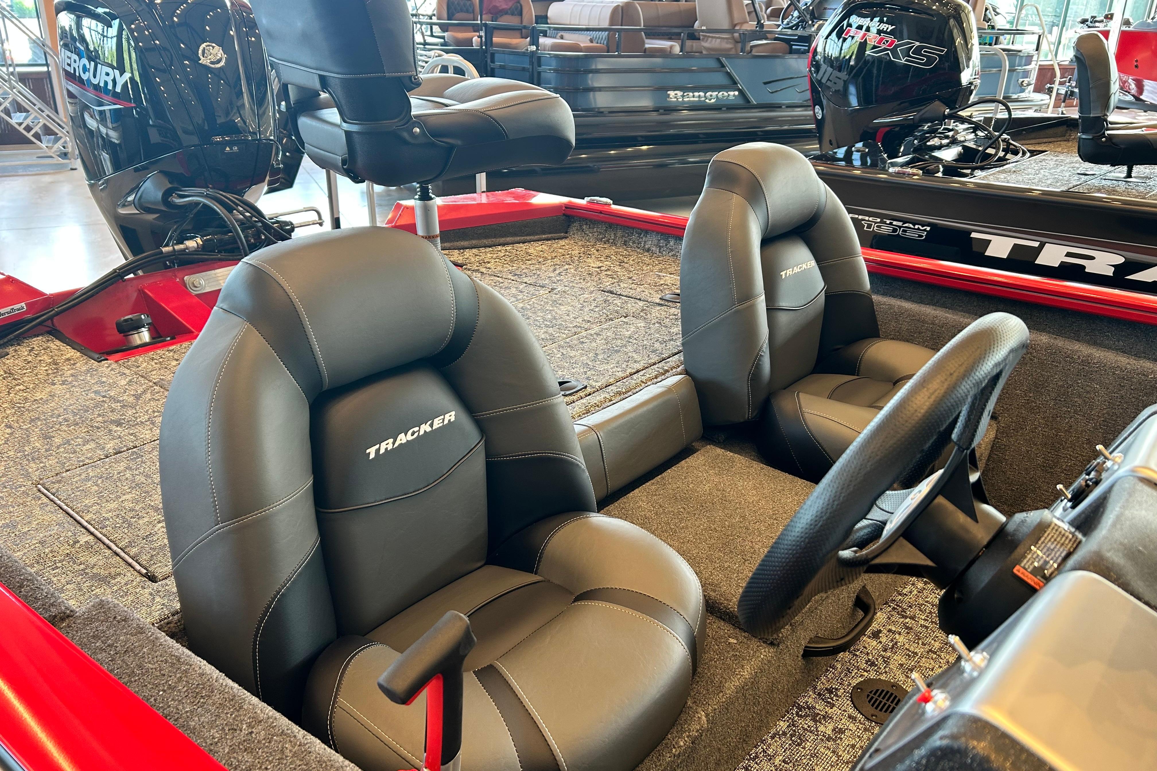 2026 Tracker Pro Team 175 boat interior with black seats and steering wheel.