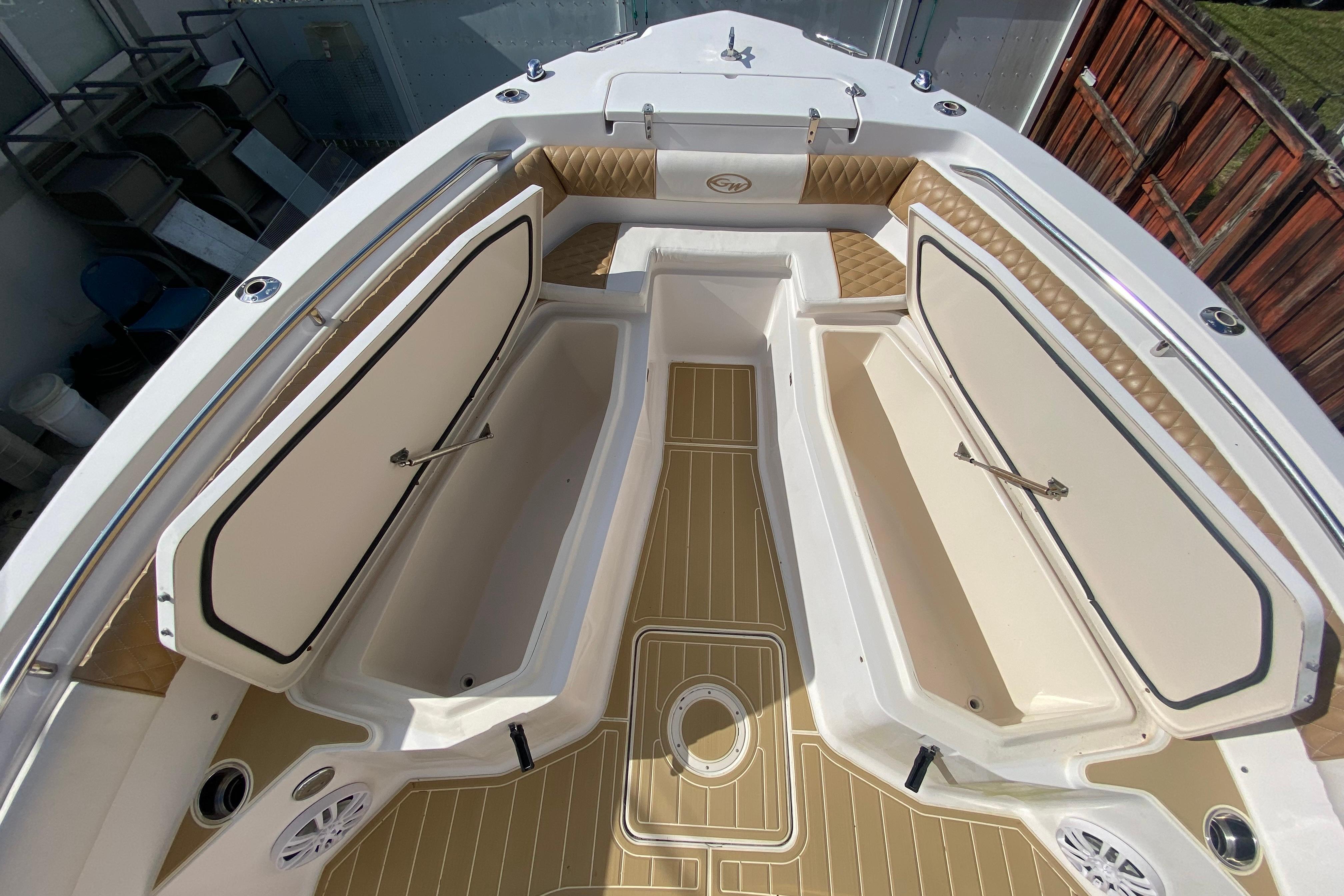 2004 Grady-White Canyon 283 boat interior with open storage compartments and cushioned seating.