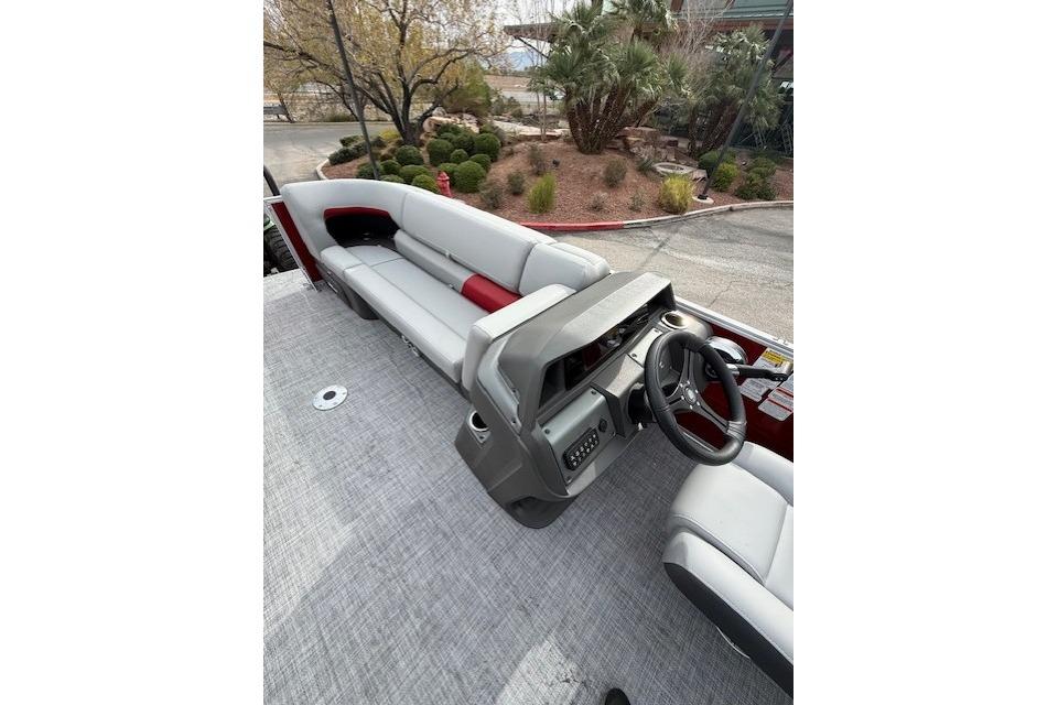 2026 Sun Tracker Party Barge 22 DLX interior with seating and steering console.