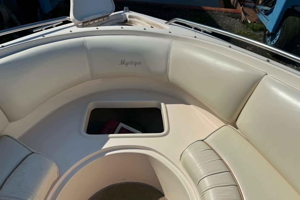 1999 Ebbtide 2300 Bow Rider boat interior with cushioned seating and storage compartment.
