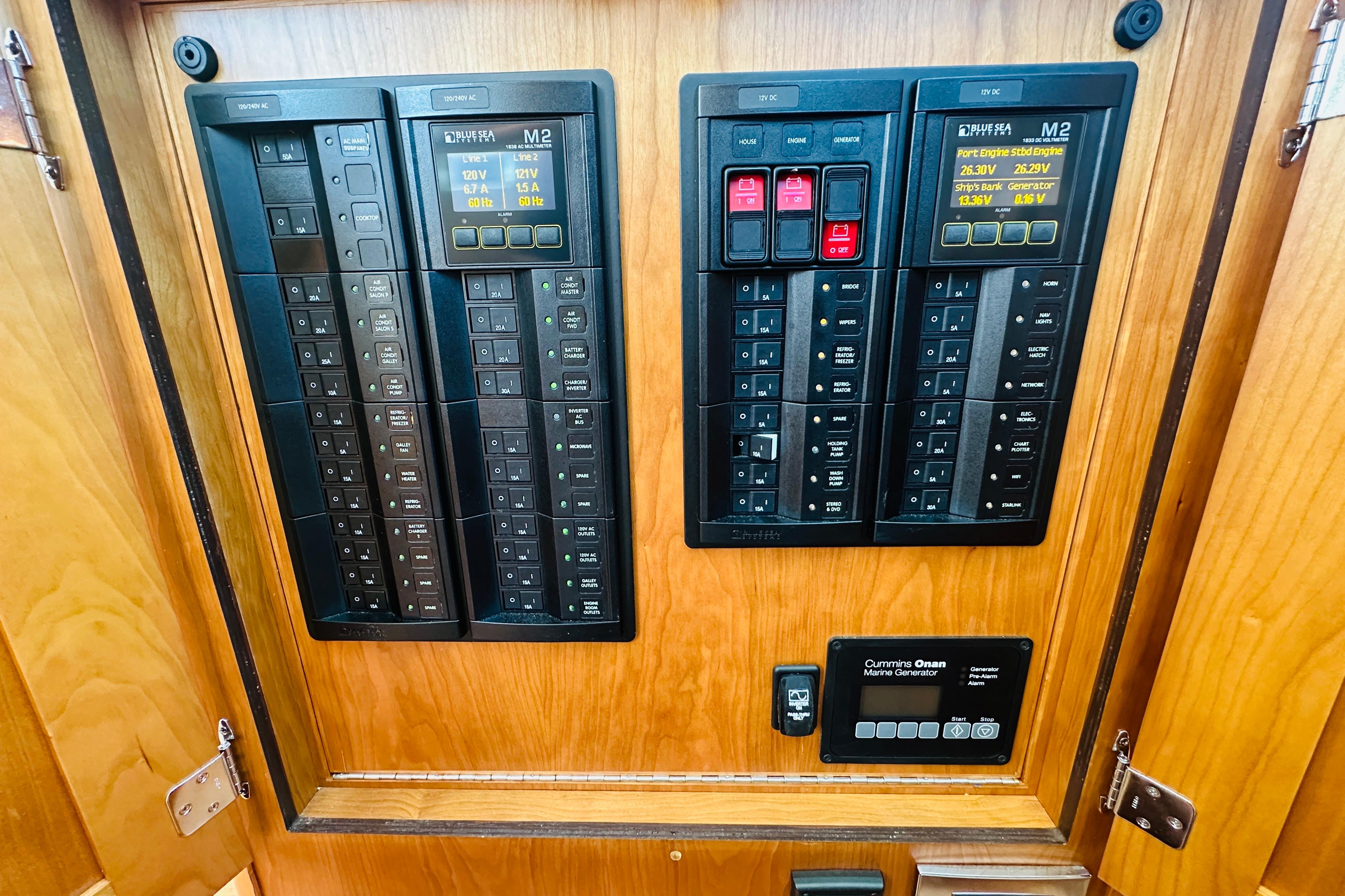 Electrical control panel on 2025 Sabre 48 Salon Express yacht, featuring circuit breakers and displays.