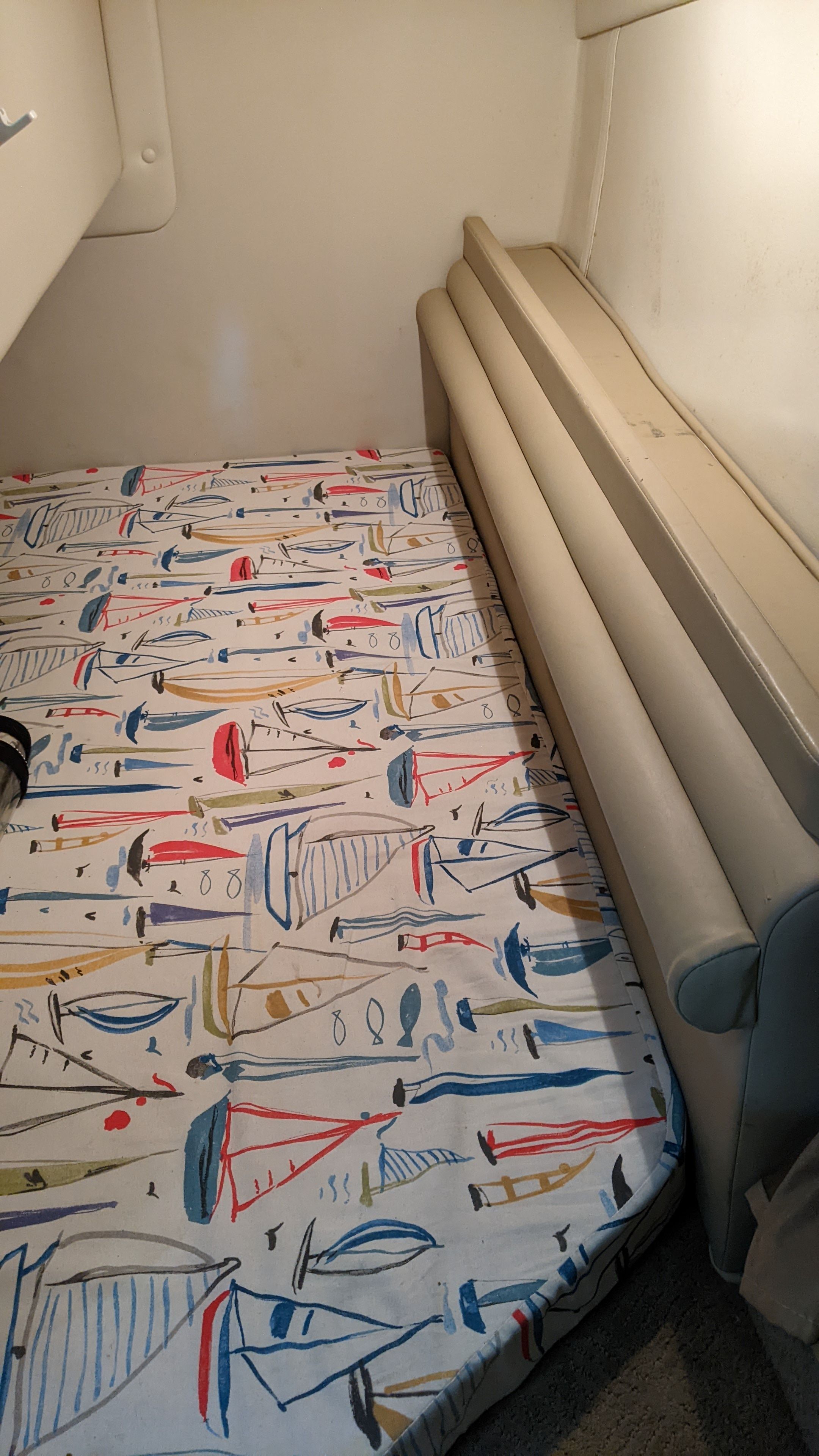 Interior of a 2006 Rinker 250 EC with patterned bedding.
