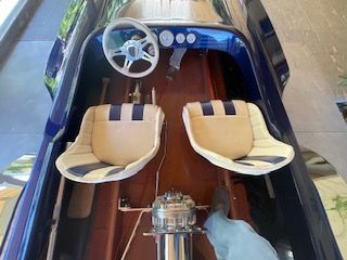 Interior view of a 1980 Sanger HYDRO V DRIVE with two seats and a steering wheel.