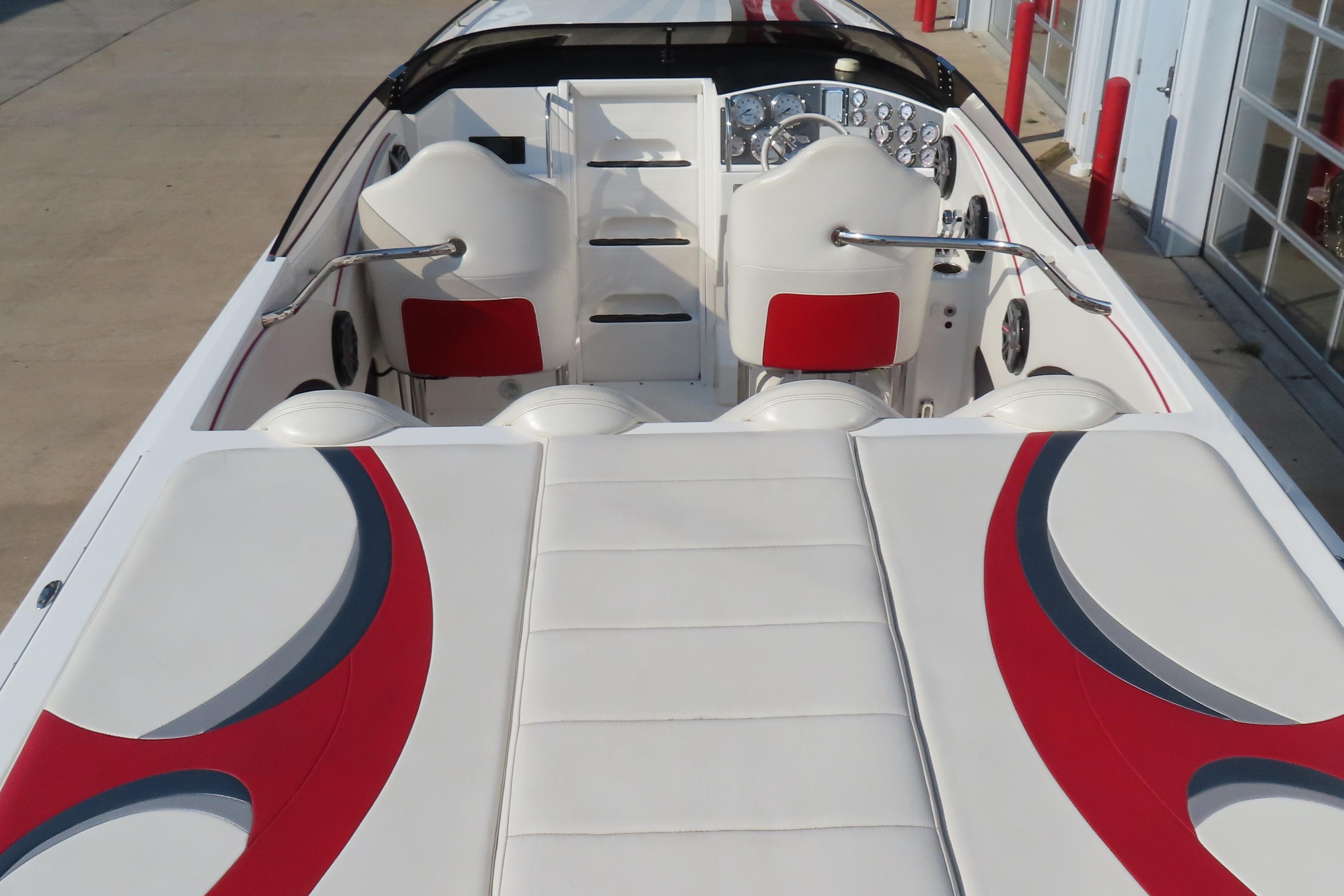 2013 Nordic 39 Poker Run boat interior with white and red seating and dashboard.