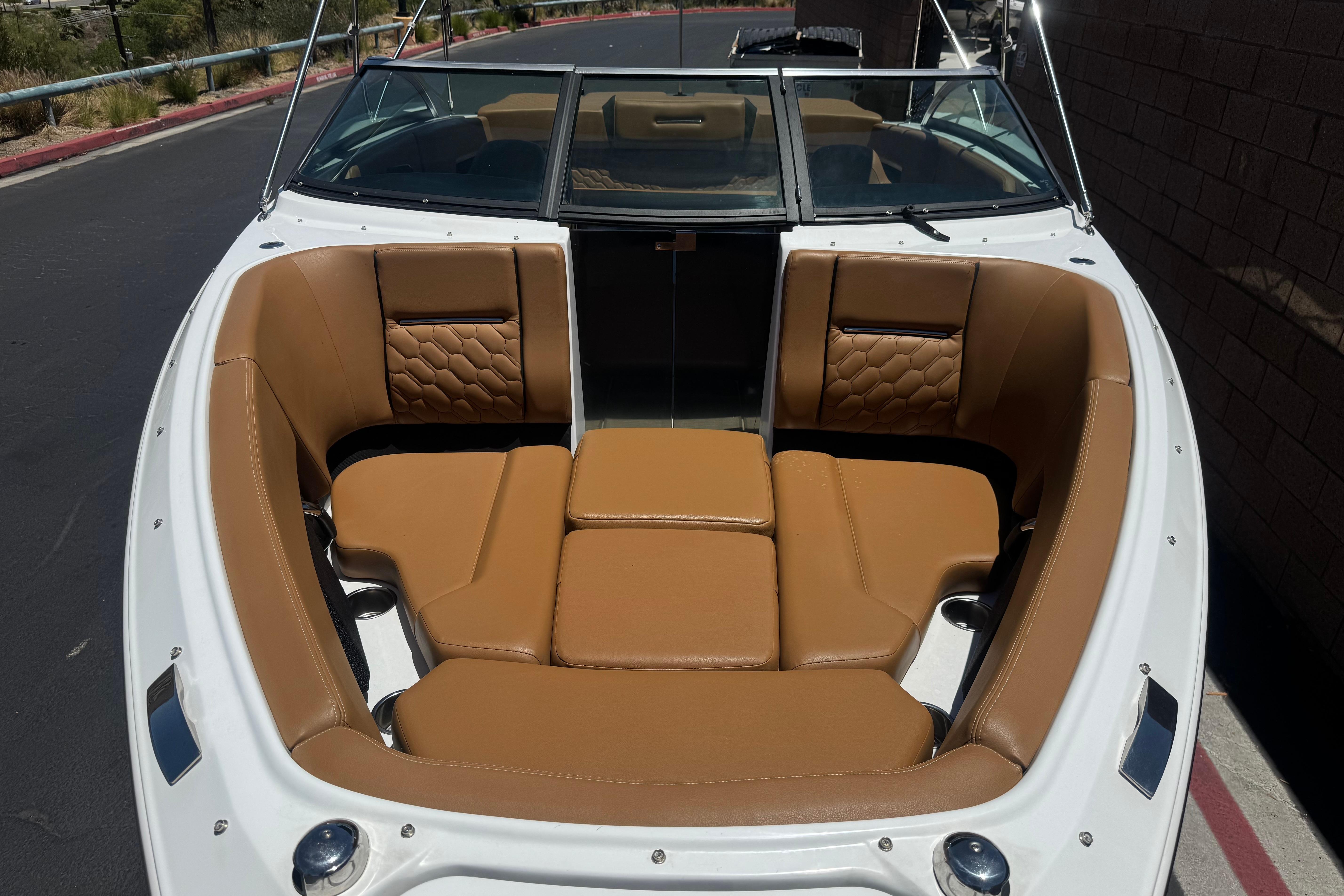 2022 Four Winns H4 boat with tan leather seating and sleek design.