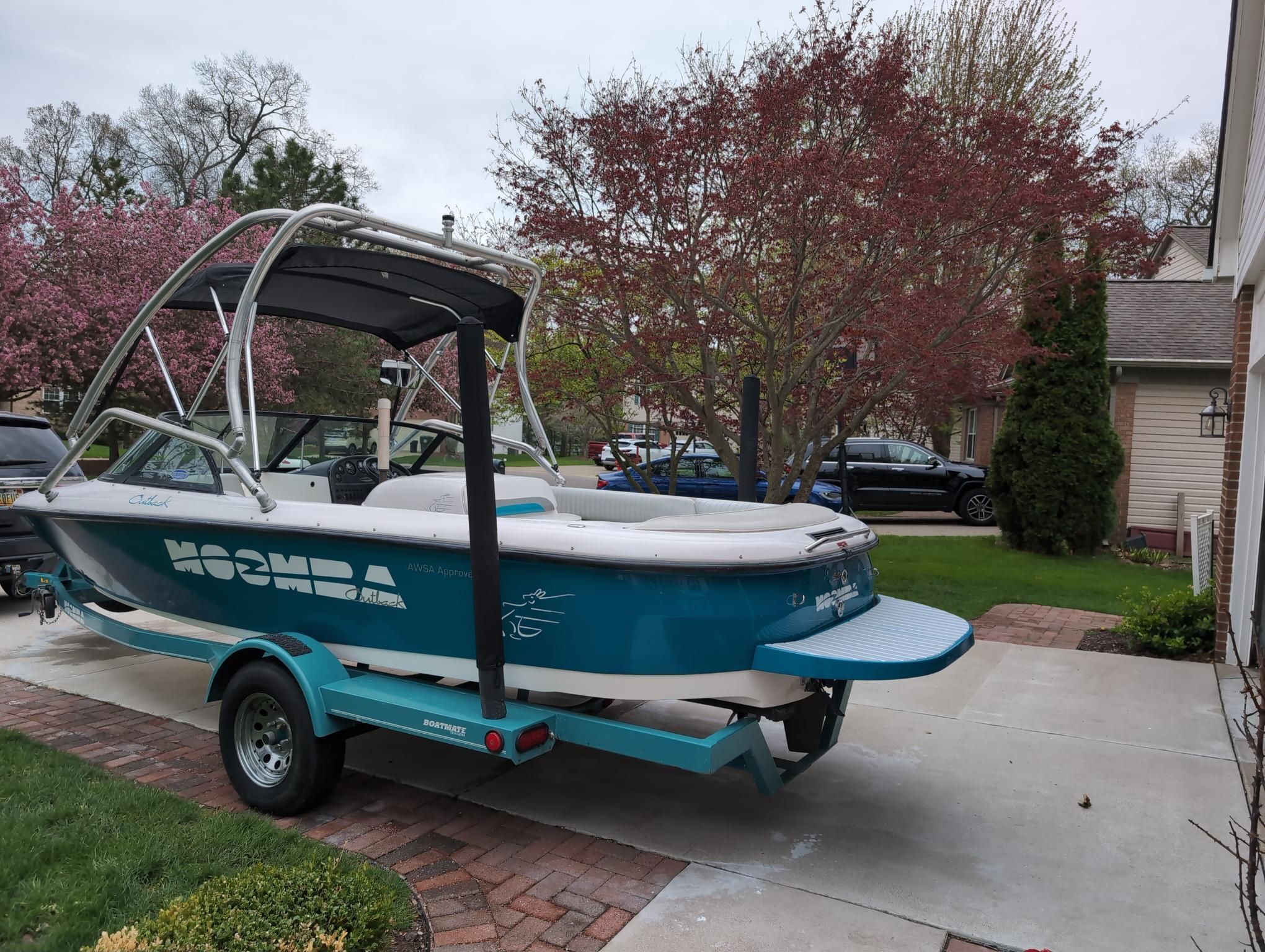 A 2000 Moomba Ouback LS on a trailer in a driveway.