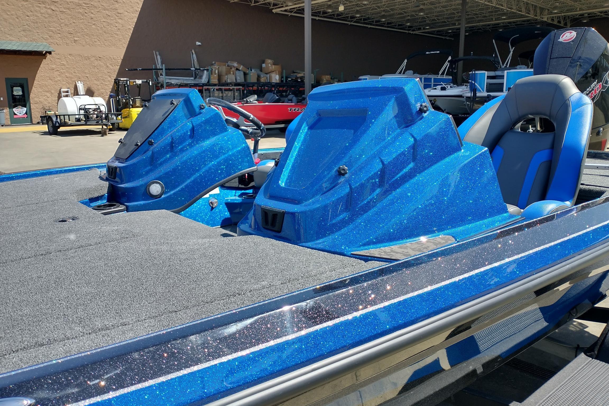 2026 Nitro Z19 XL boat with sparkling blue finish and dual consoles in a showroom.