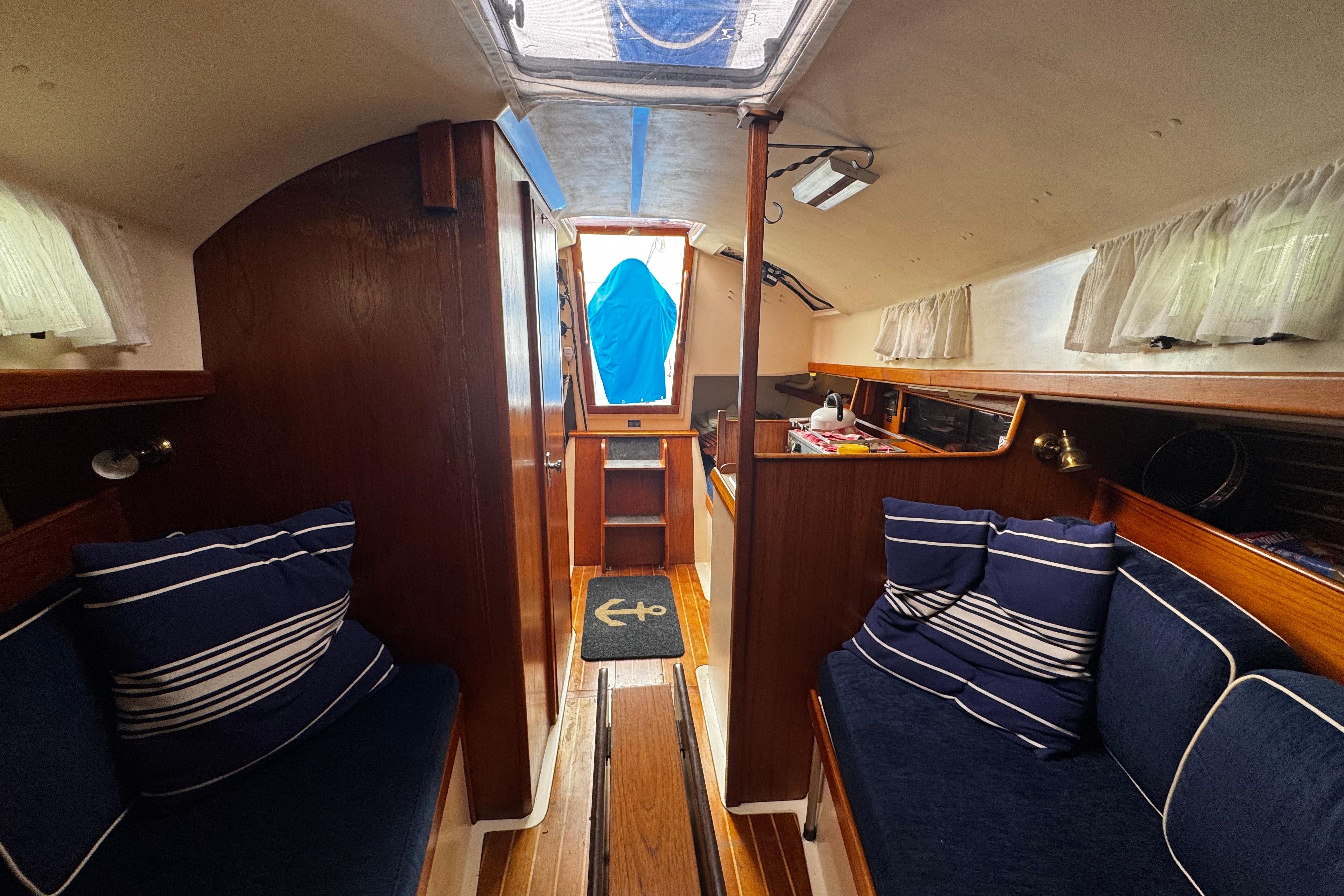 Interior of 1984 Nonsuch 26 Classic sailboat with cozy seating and nautical decor.