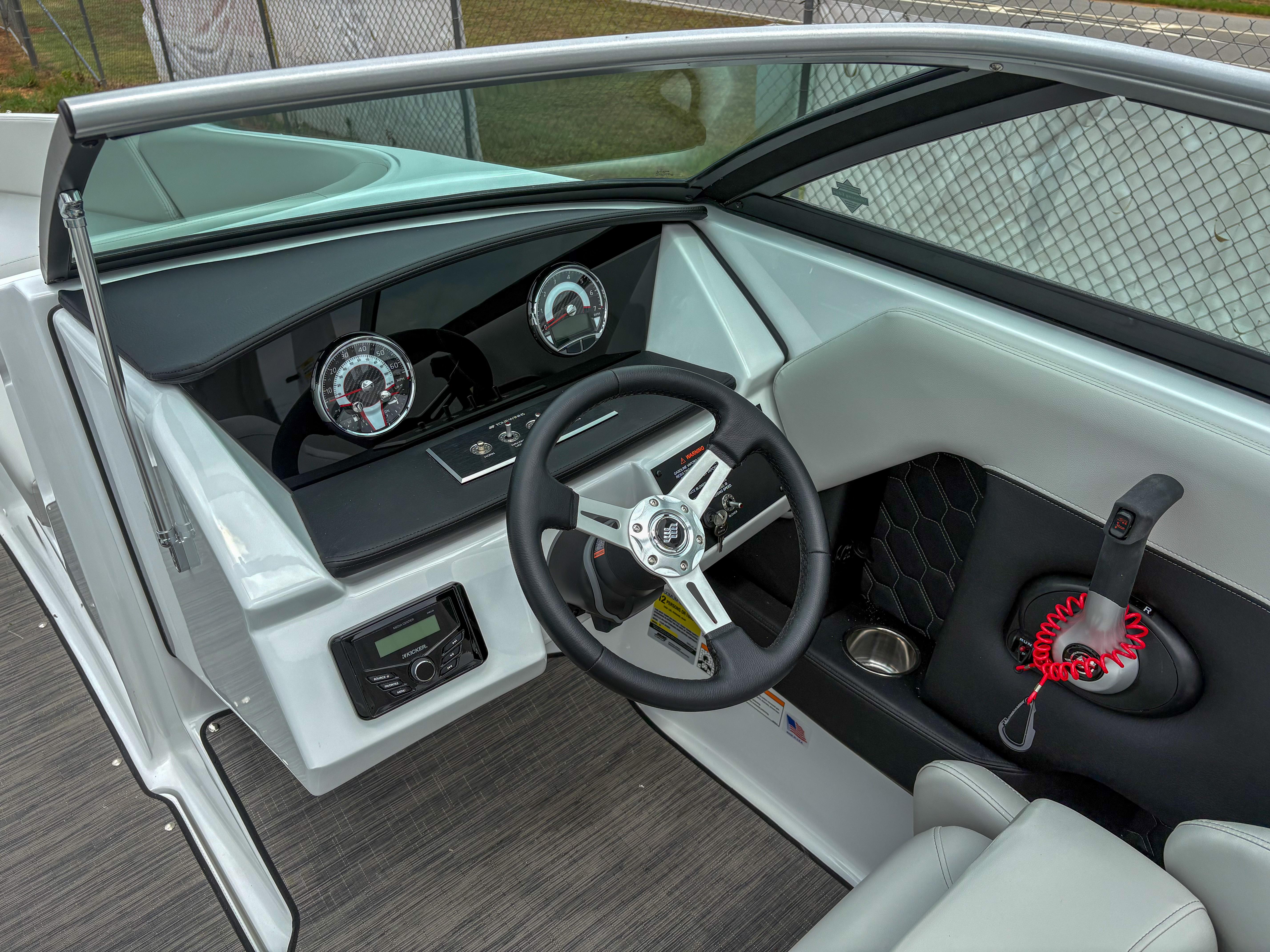 2026 Four Winns H2 Freedom boat dashboard with steering wheel and control panel.