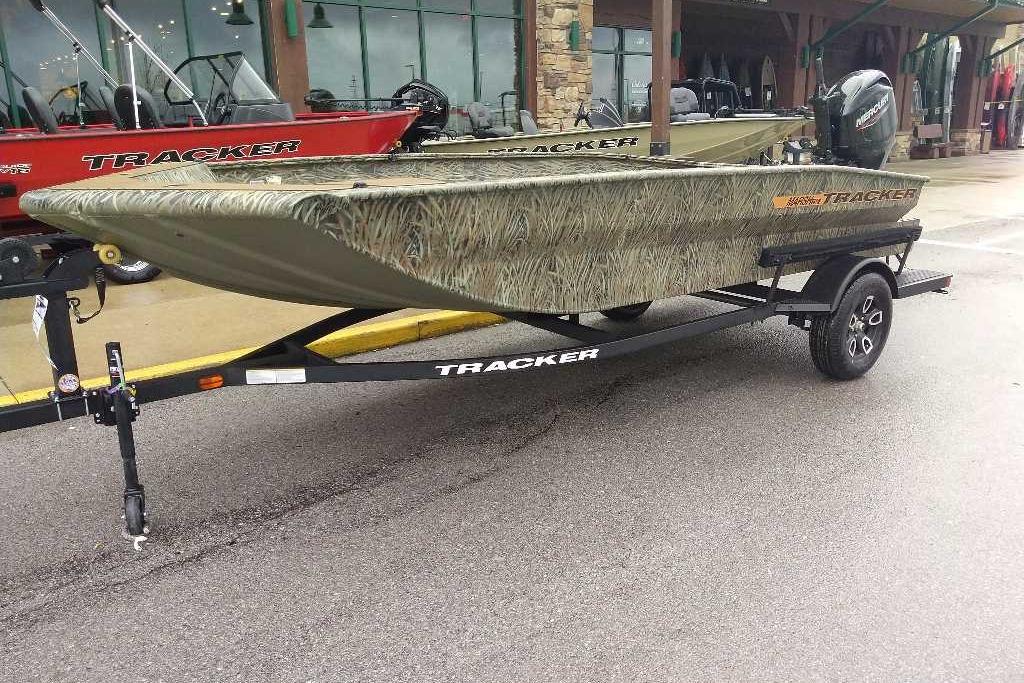 2026 Tracker Grizzly 1756 T Marsh boat on trailer, camo design, parked outdoors.
