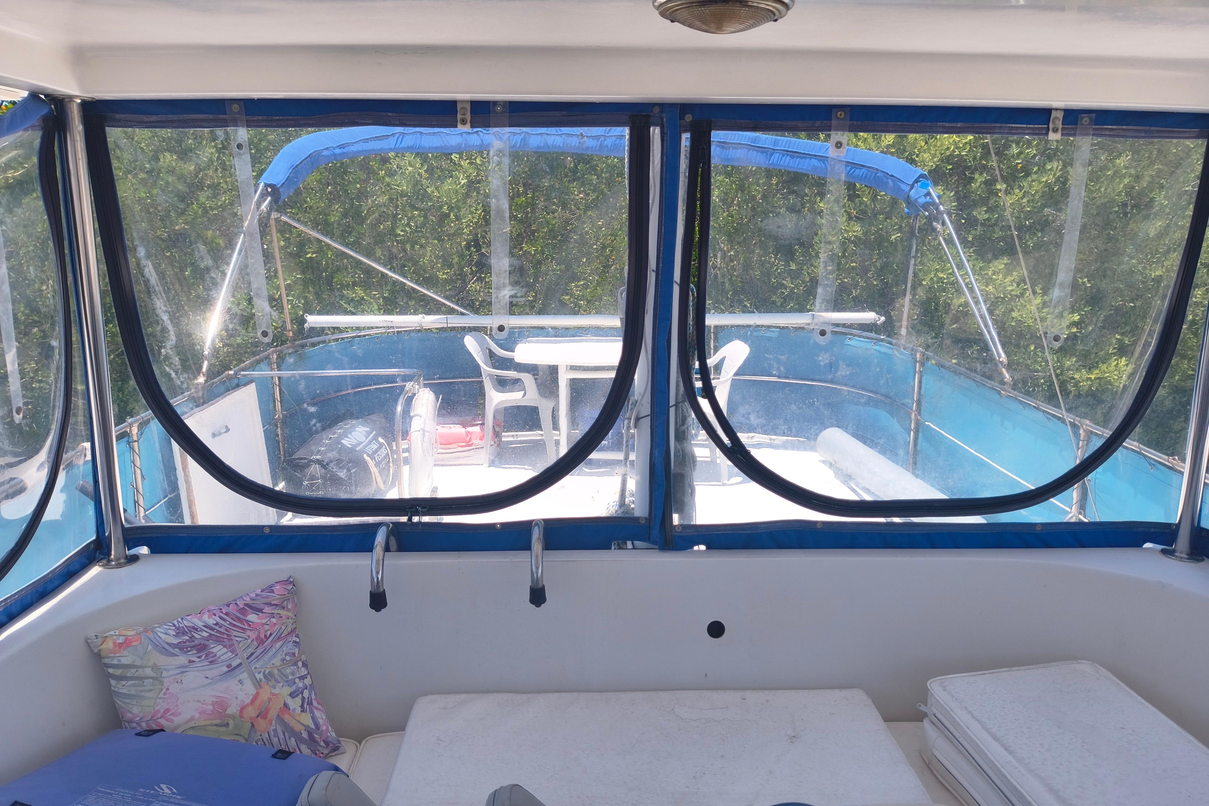 1984 Kadey-Krogen Manatee boat interior with blue canopy and outdoor seating area.