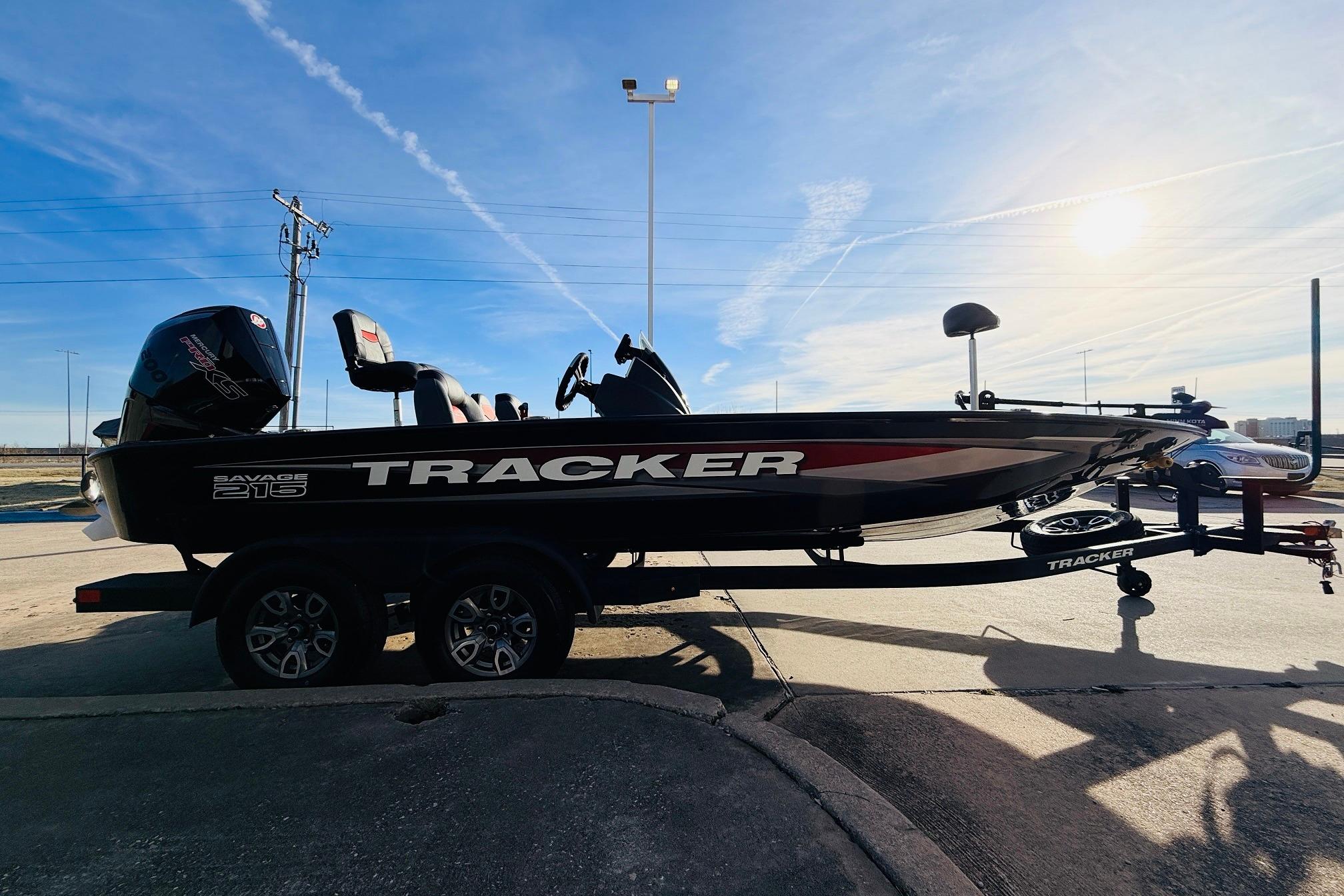 2025 Tracker Savage 215 boat on trailer under clear blue sky.