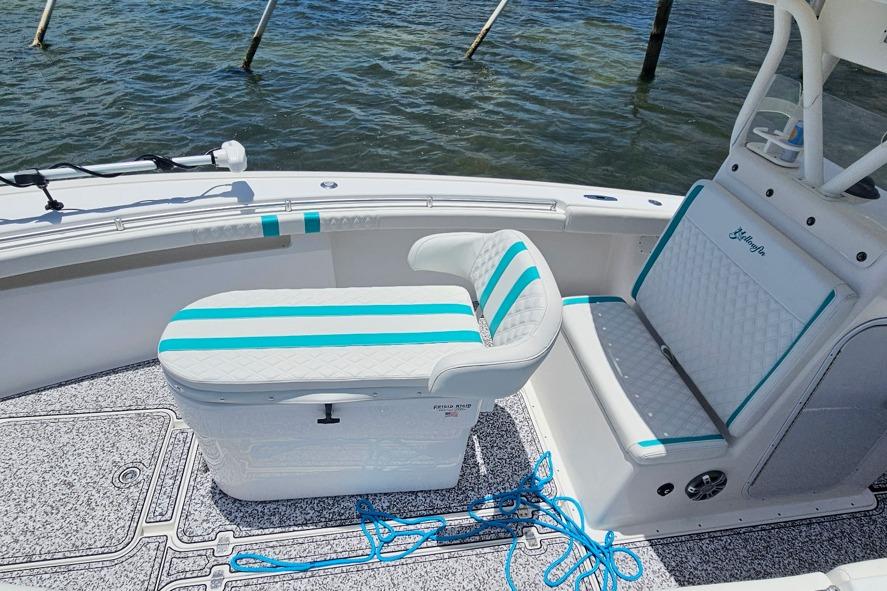 2002 Yellowfin 31 Center Console boat interior with striped seating and blue accents.