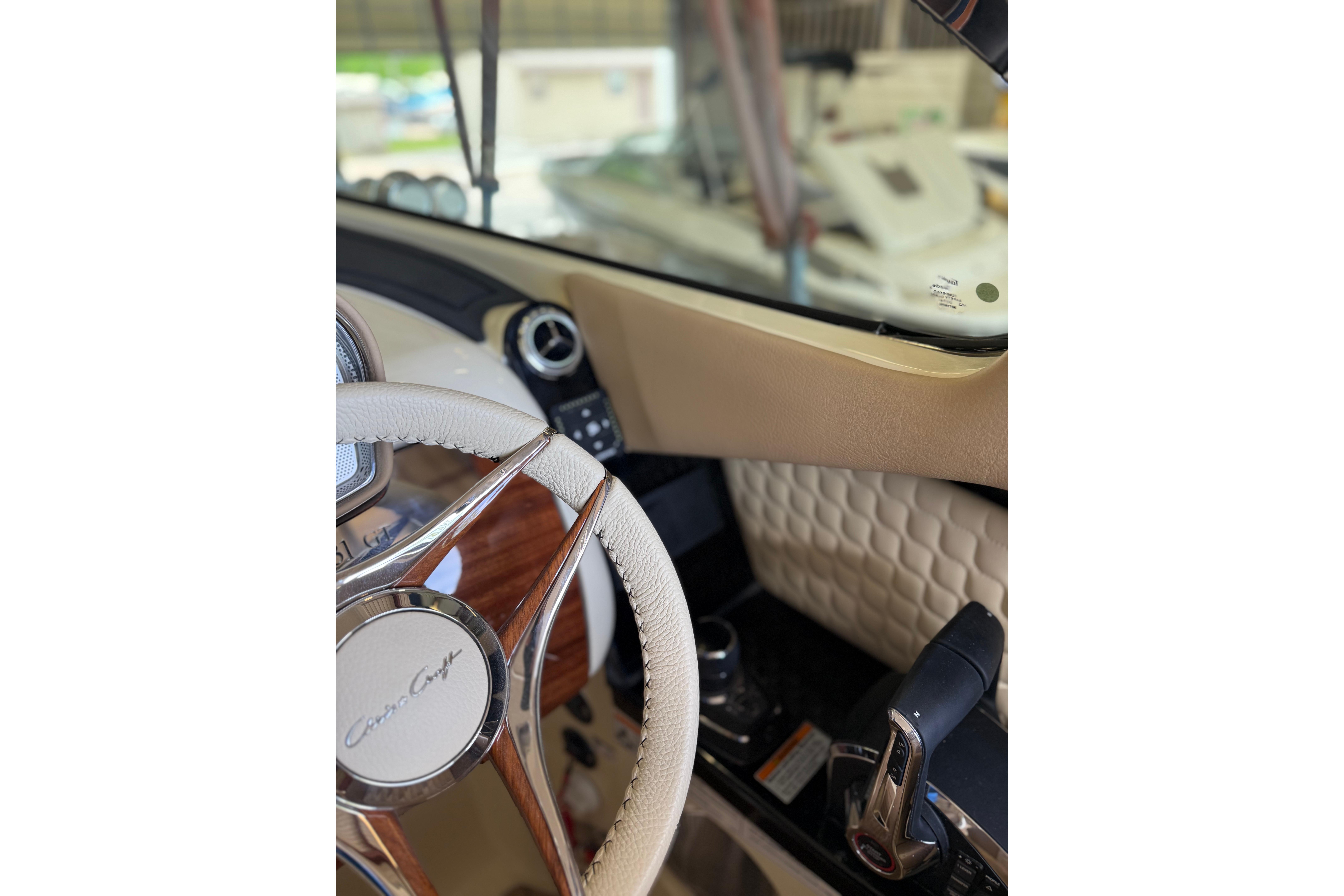 Interior view of 2026 Chris-Craft Launch 31 GT, featuring steering wheel and dashboard.