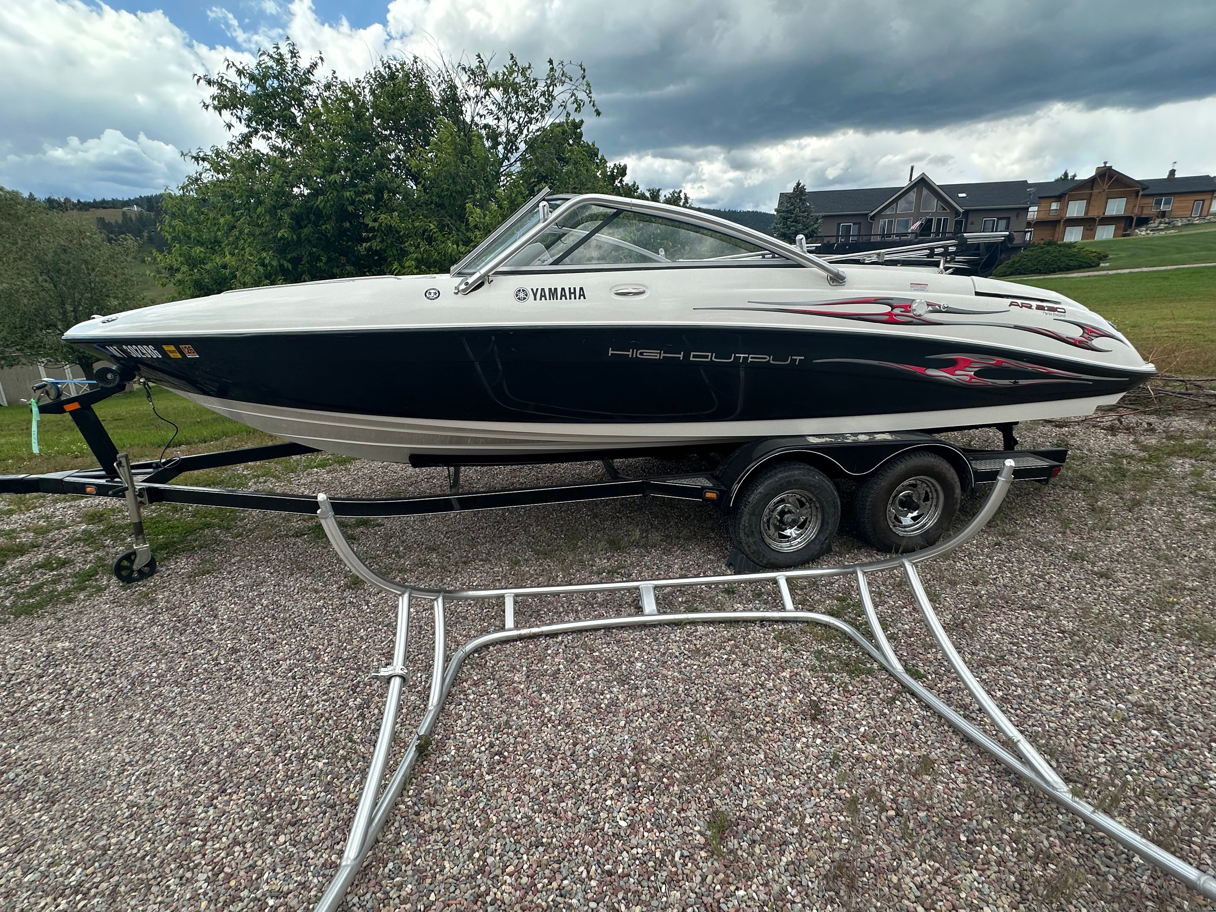 2005 Yamaha AR230 HO boat on trailer, parked outdoors.