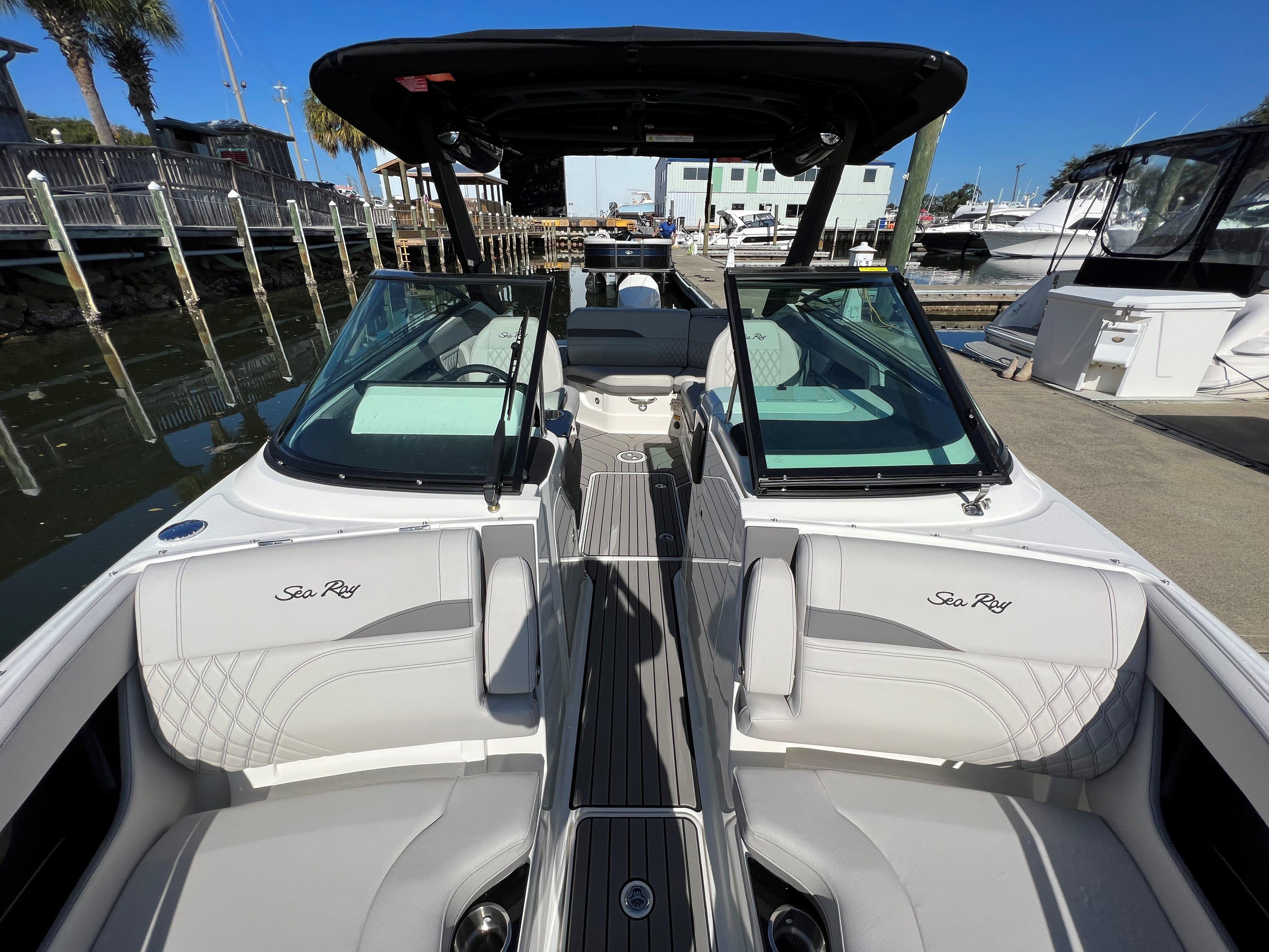 2023 Sea Ray SLX 260 Outboard boat interior at marina, featuring luxurious seating and sleek design.