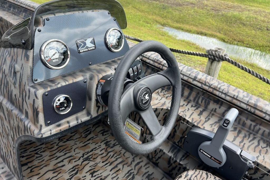 Steering console of 2026 Xpress XP200 boat with camouflage design and Yamaha controls.