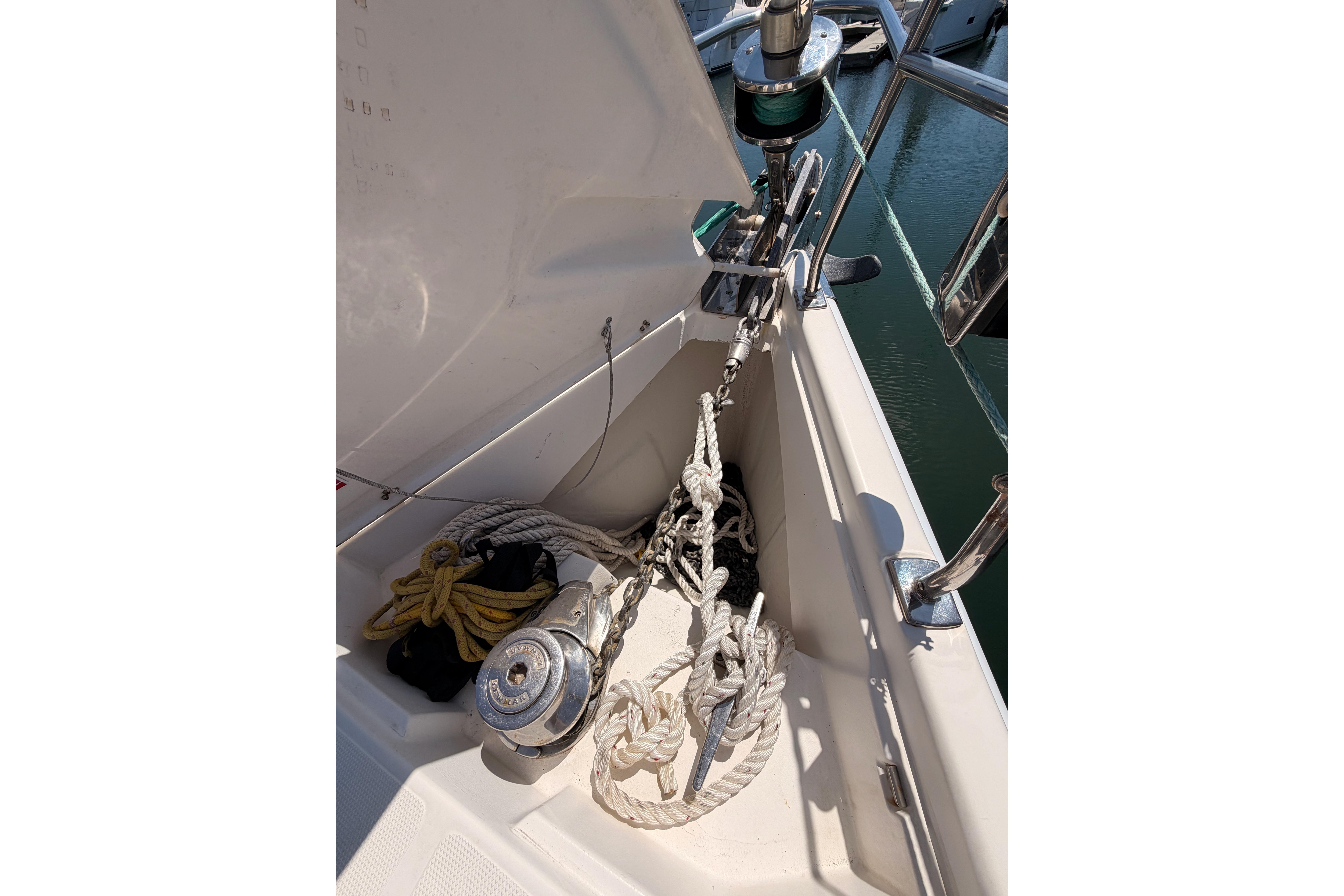 Anchor and ropes on 2008 Hunter 45 Deck Salon sailboat, docked in marina.