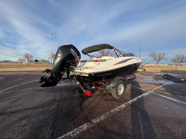 2023 Tahoe T16 boat on trailer in parking lot, under clear sky.