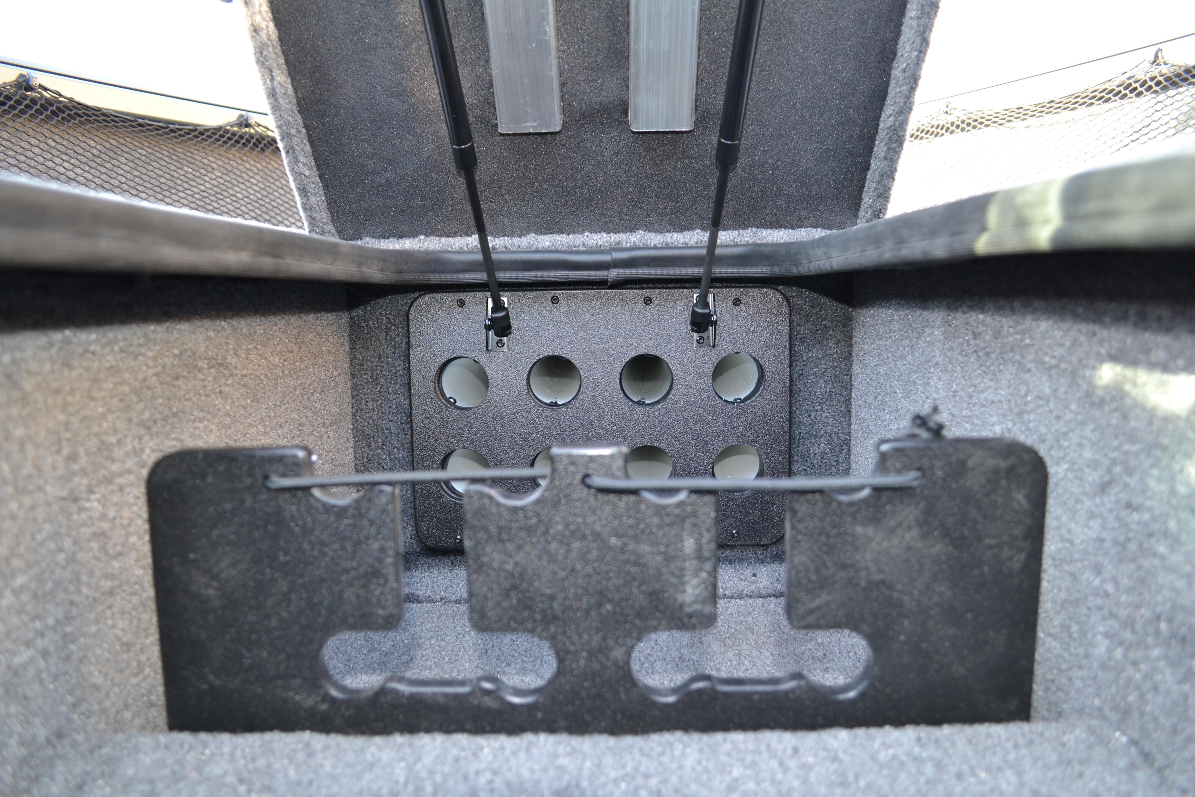 2026 Ranger VS1882SC Reata boat storage compartment with rod holders and carpeted interior.