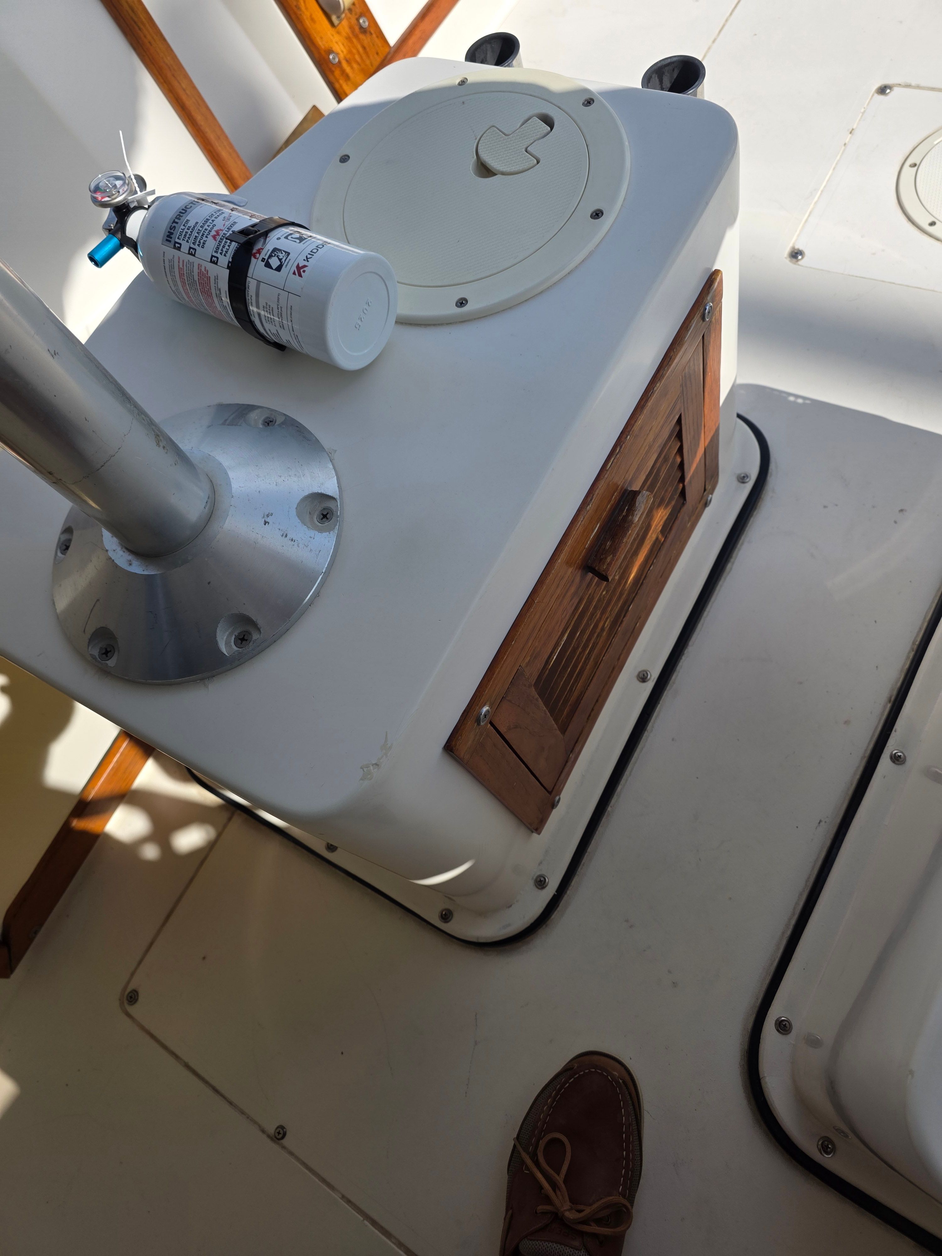 Interior of a 1987 Mako 248 WAC boat with fire extinguisher.