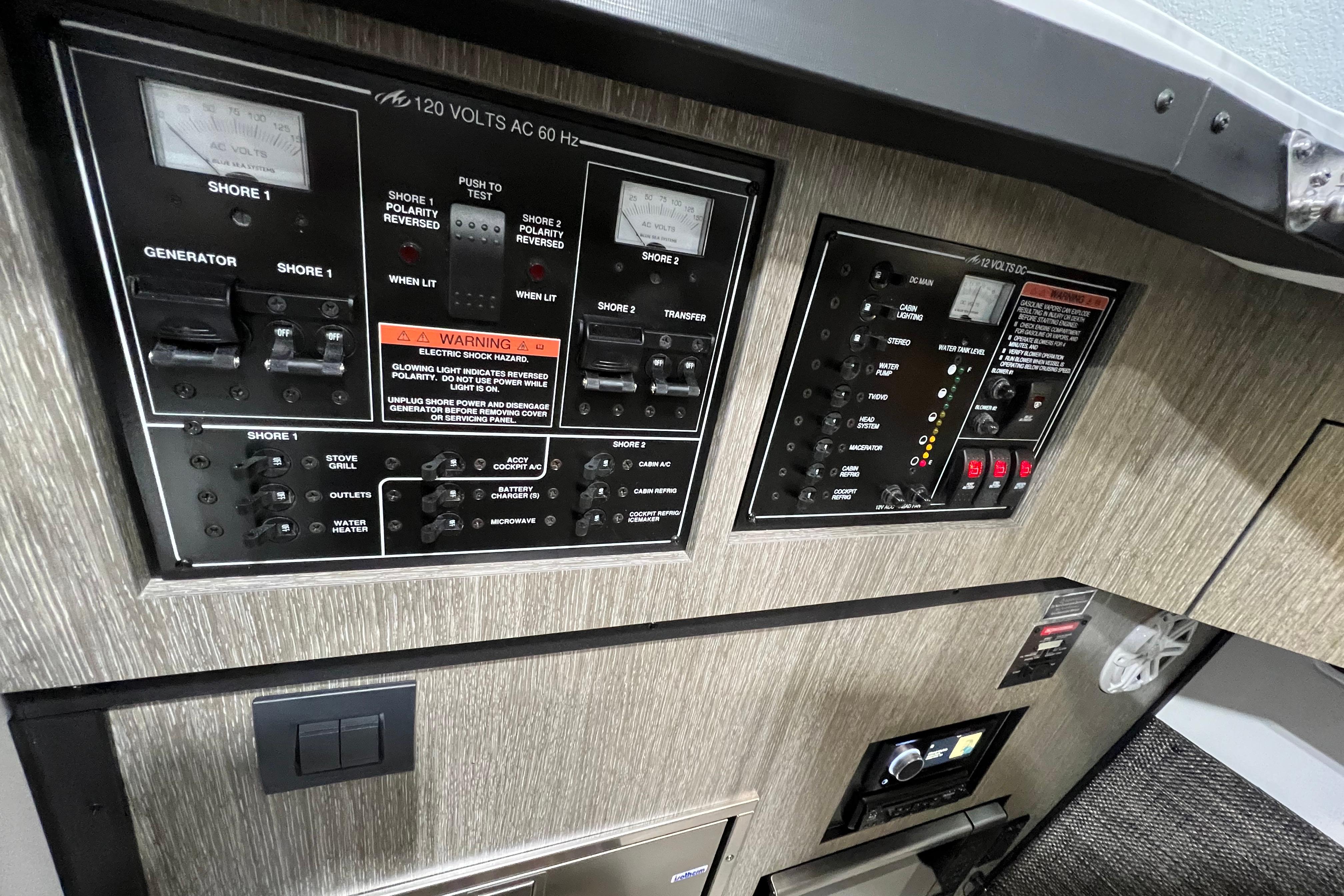 Electrical control panel of 2023 Monterey 378SS Super Sport boat, featuring various switches and gauges.