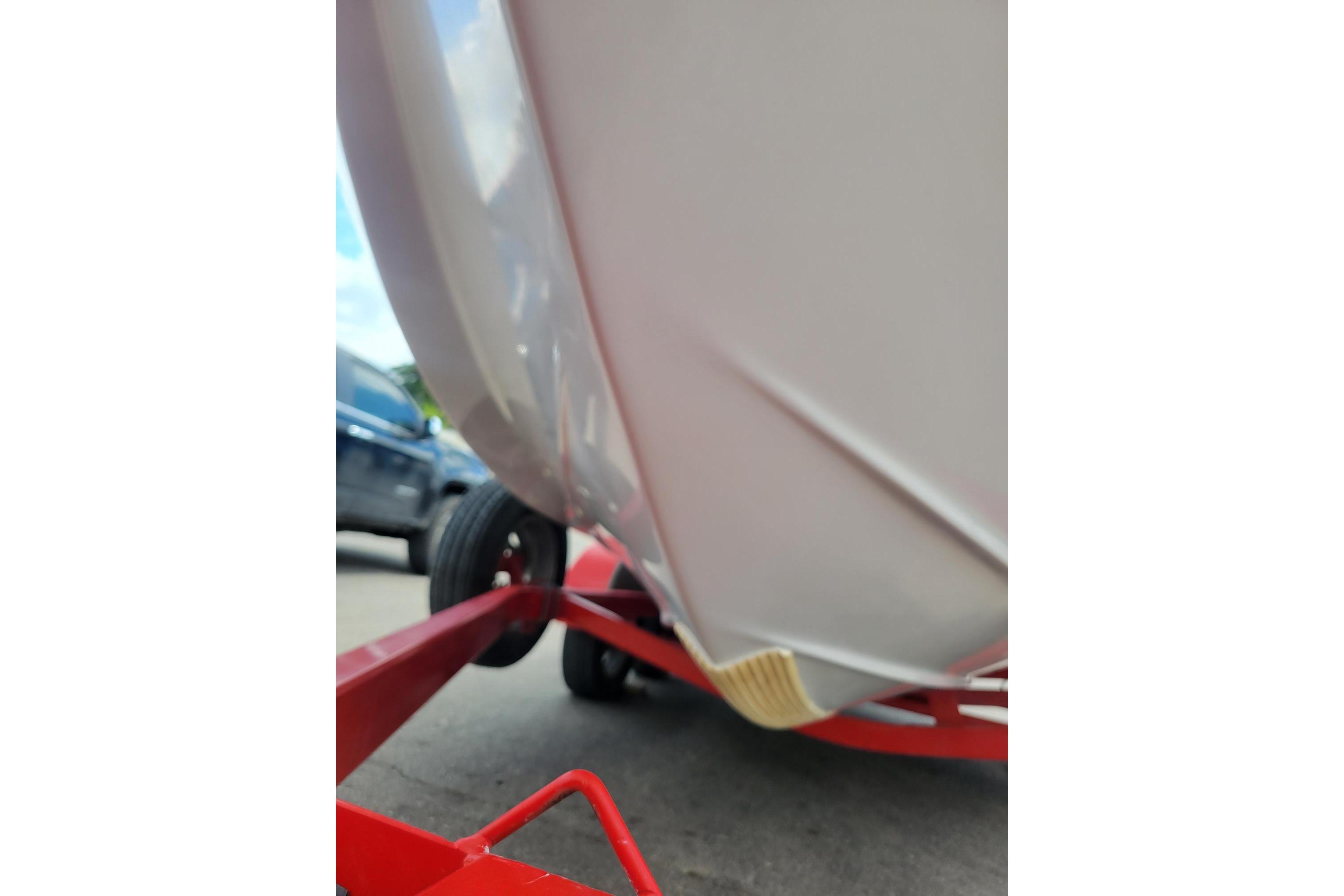 Close-up of 2007 Four Winns 200 Horizon boat hull on red trailer.