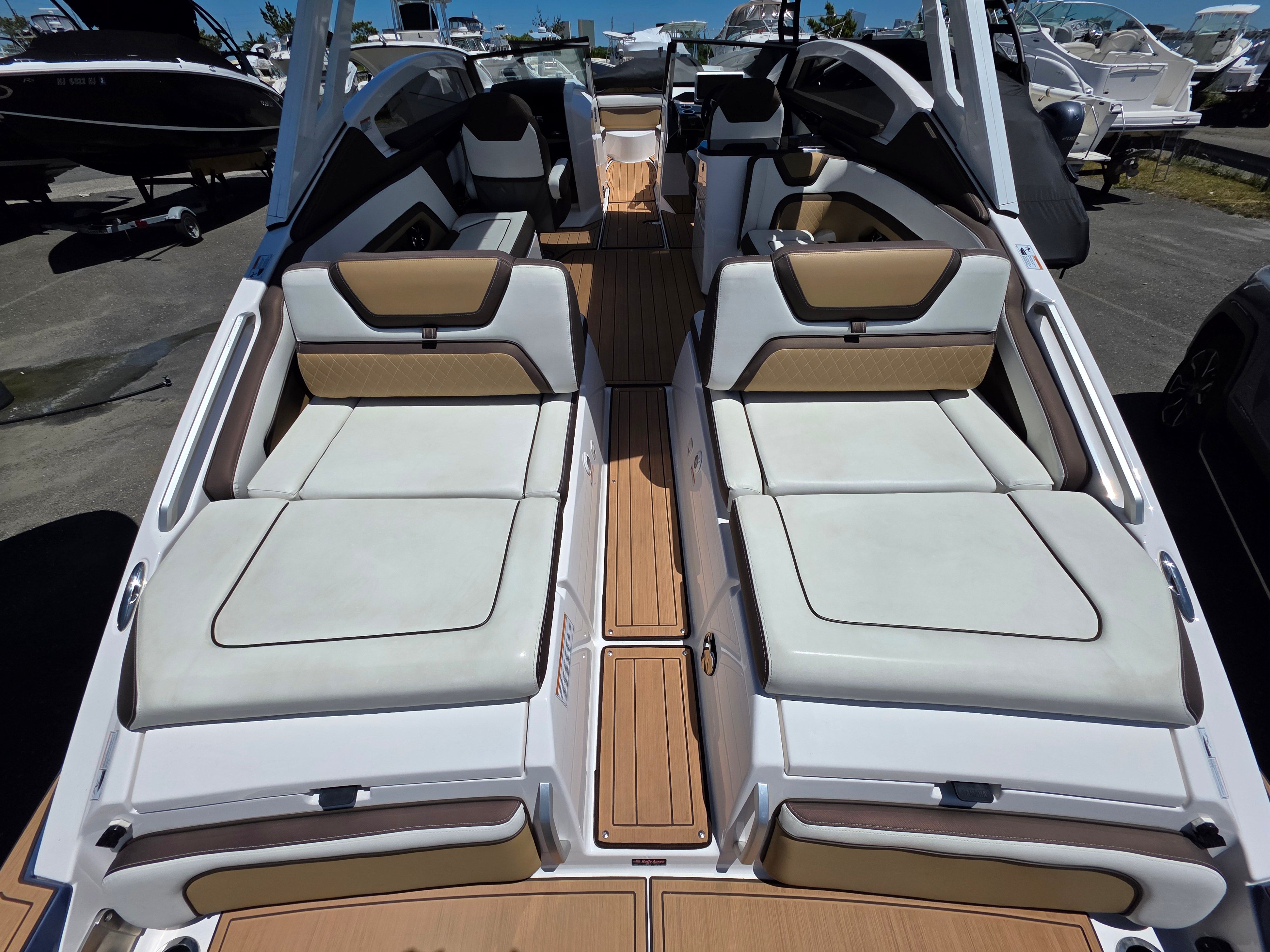 The image shows the stern of a 2023 Yamaha Boats sd275 with luxurious lounging areas.