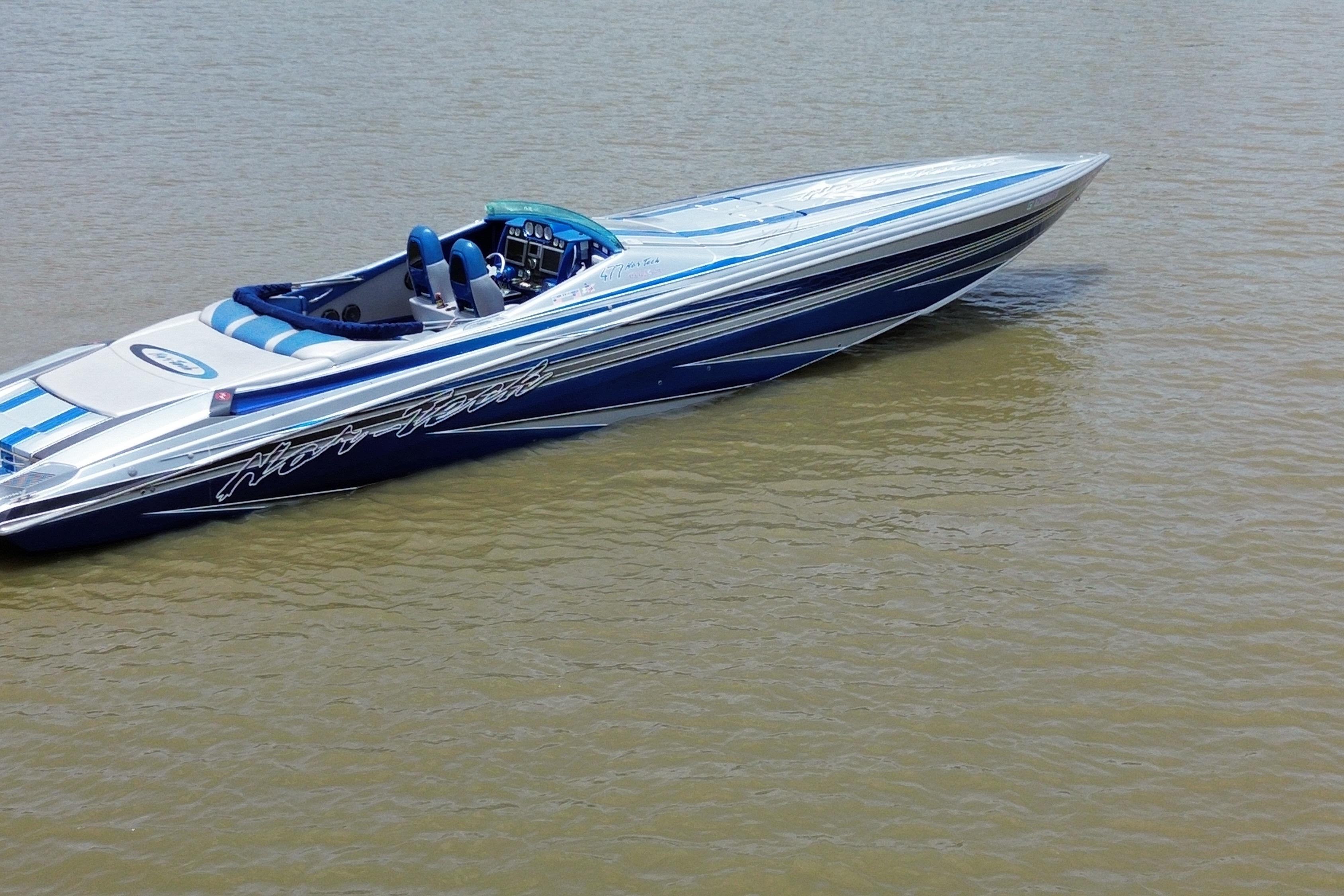 2013 Nor-Tech 477 SPX Vee Bottom boat on calm water, featuring sleek blue and white design.