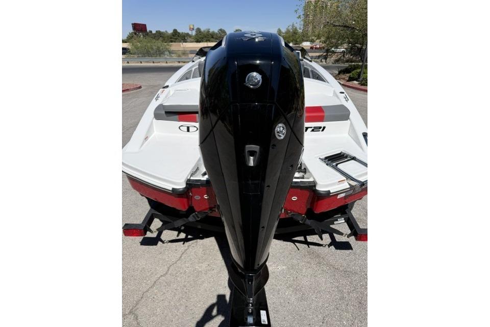 2026 Tahoe T21 boat with a sleek black outboard motor, parked on a trailer.