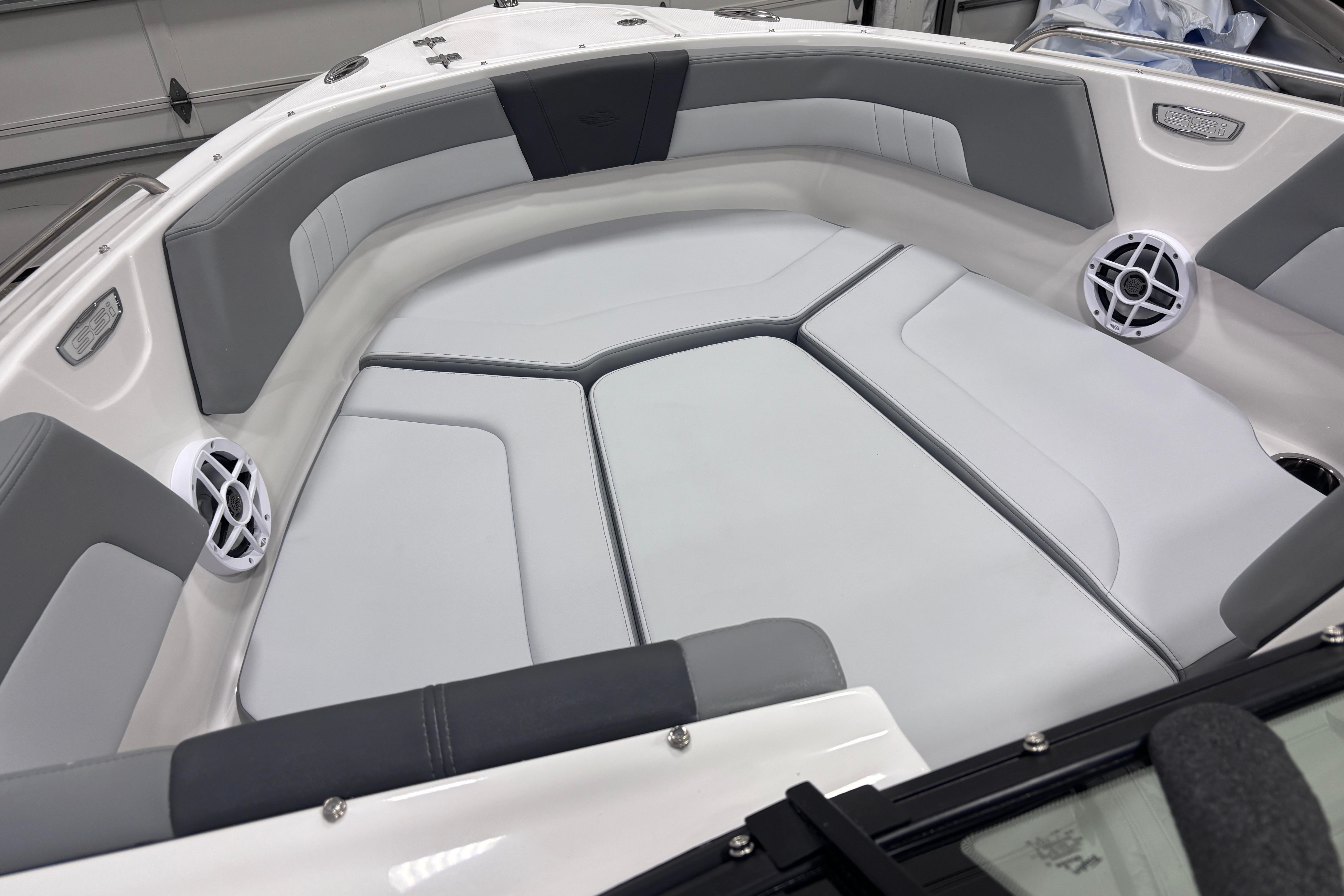 2026 Chaparral 23 SSi boat interior with gray and white cushioned seating.