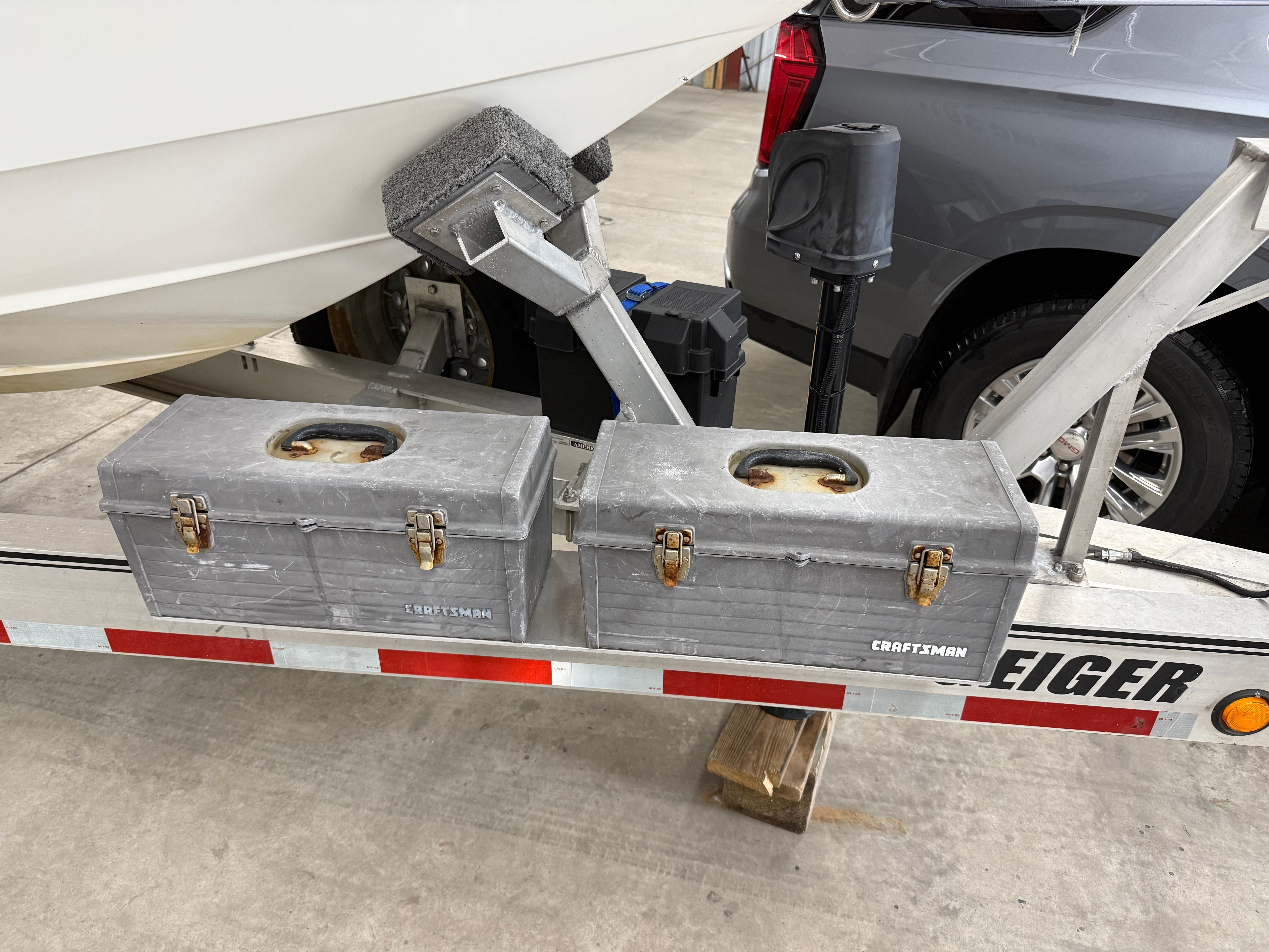 Two Craftsman toolboxes on a boat trailer.