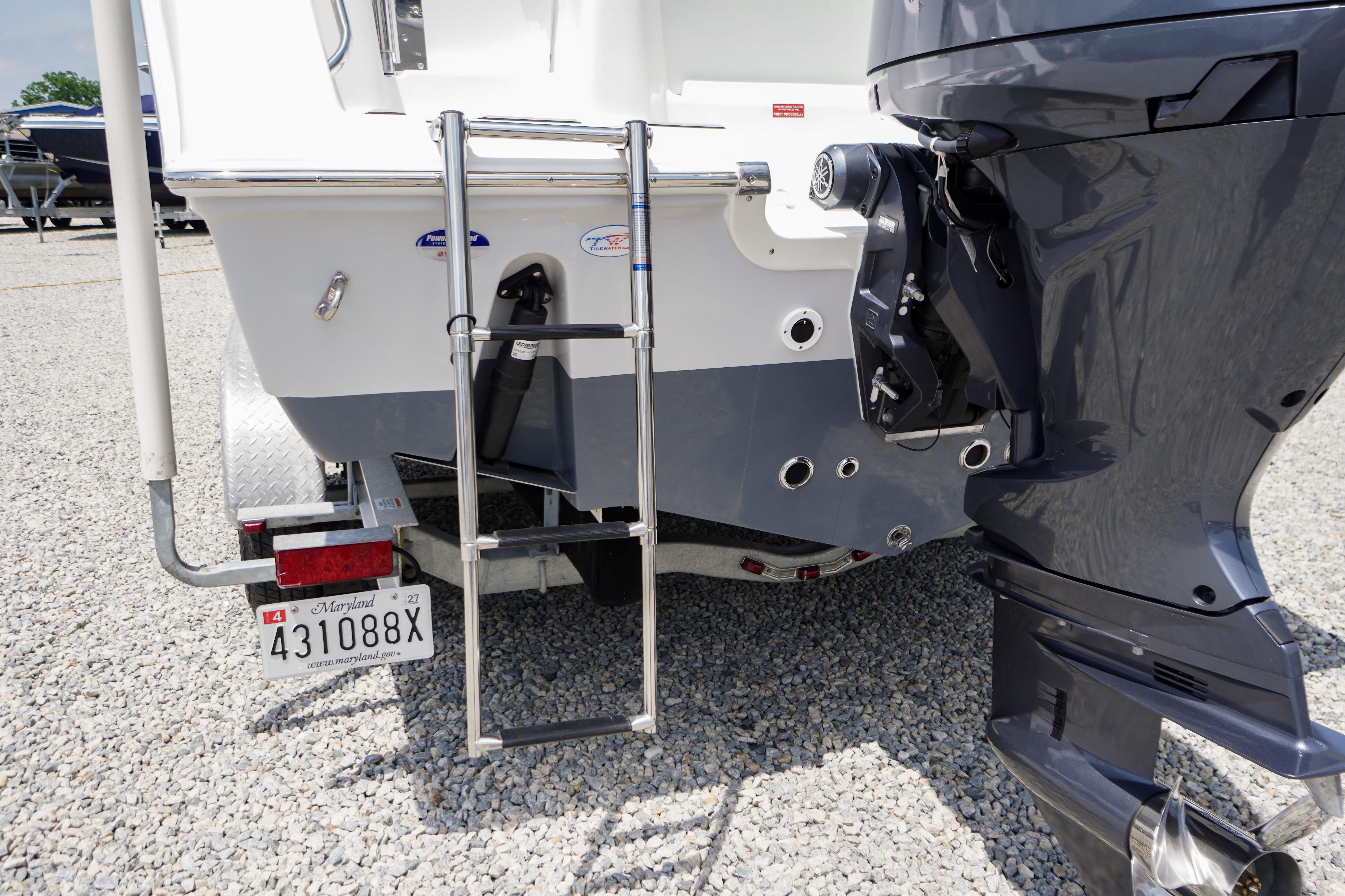 2027 Tidewater 220 CC Adventure boat rear view with ladder and motor.