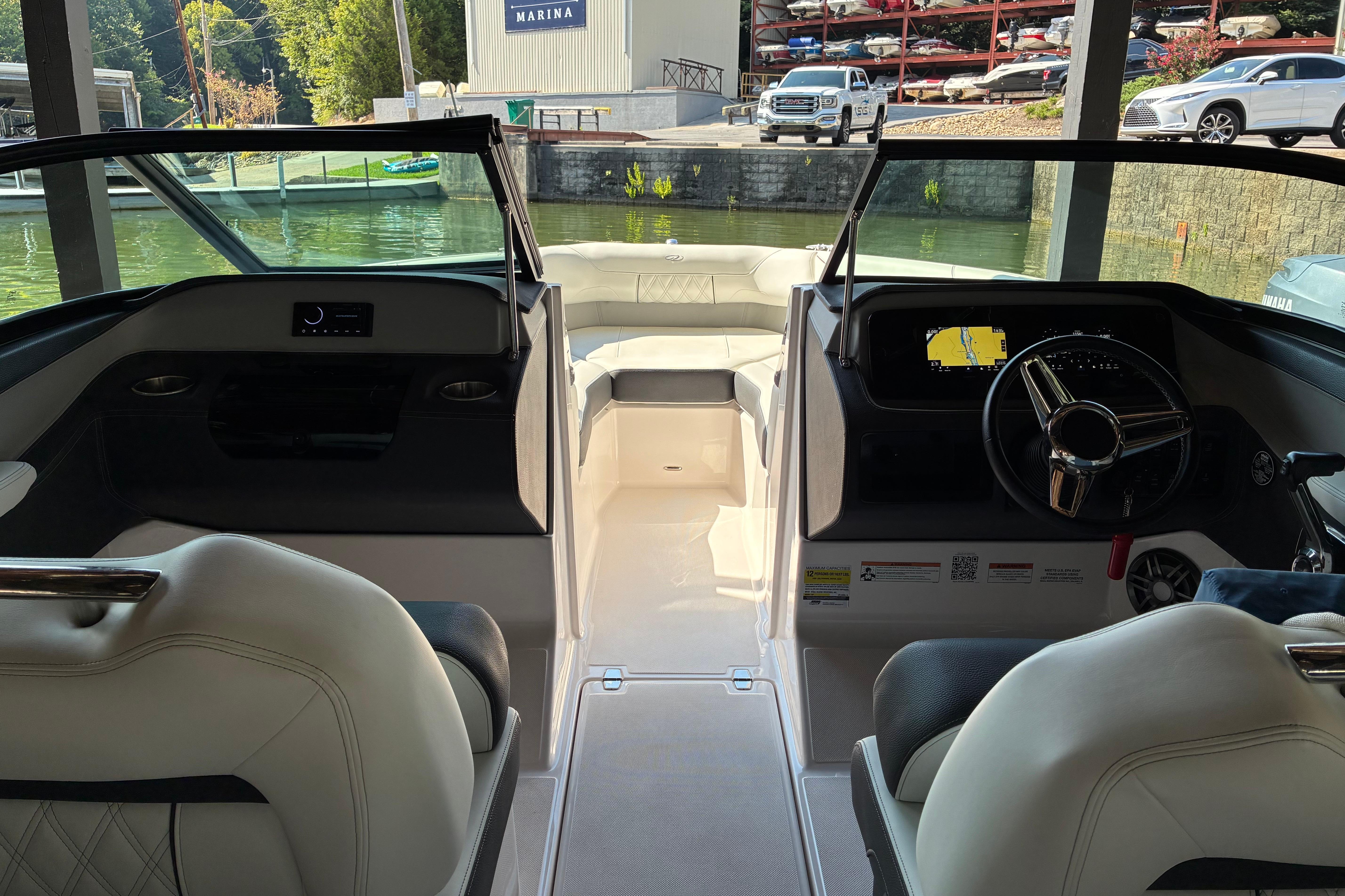 Interior view of 2025 Regal LS2 boat at marina, featuring modern dashboard and seating.