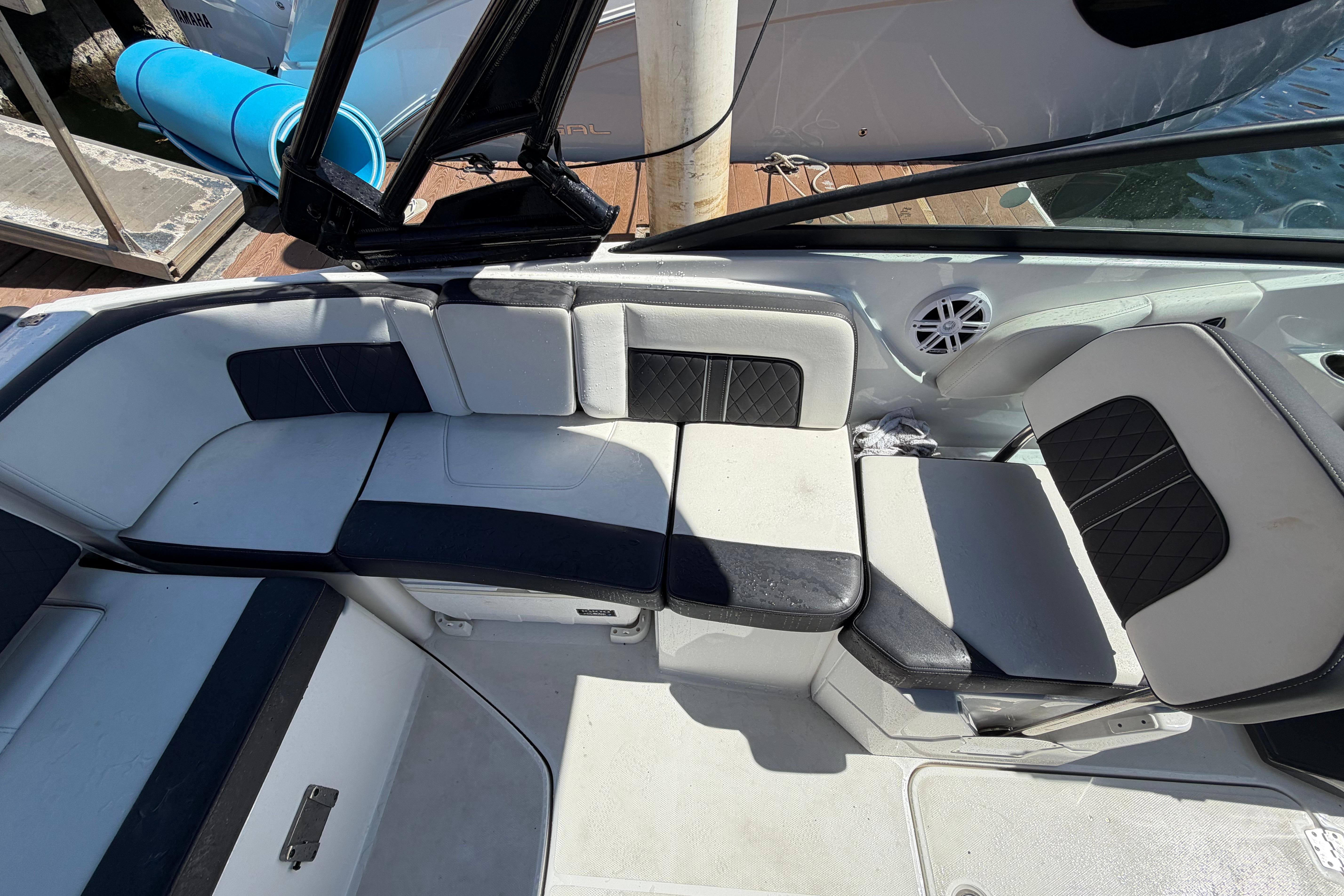 Interior seating of a 2022 Monterey M-65 boat, featuring black and white upholstery.