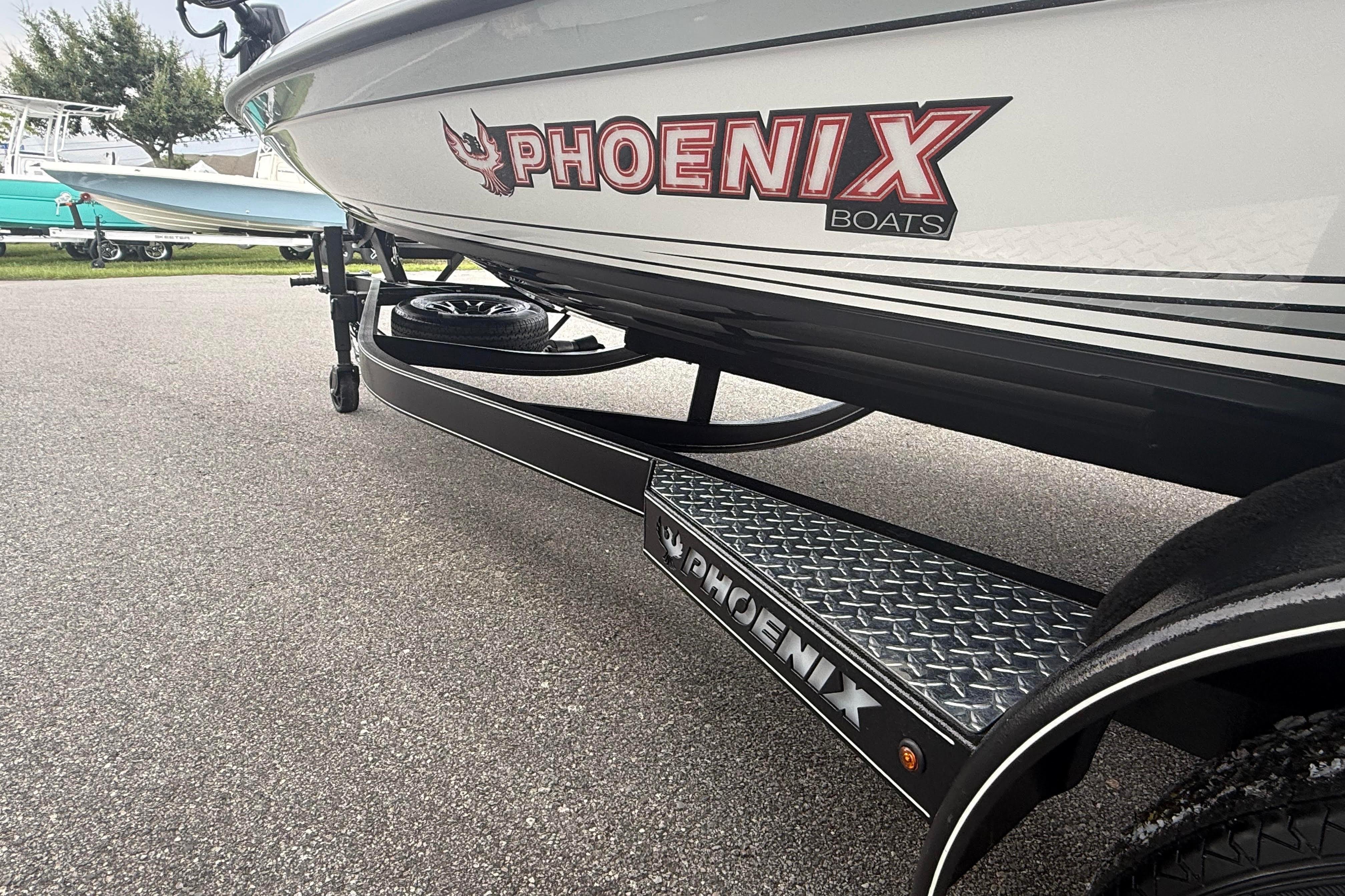 2027 Phoenix 921 Elite X II boat on trailer, showcasing logo and design details.