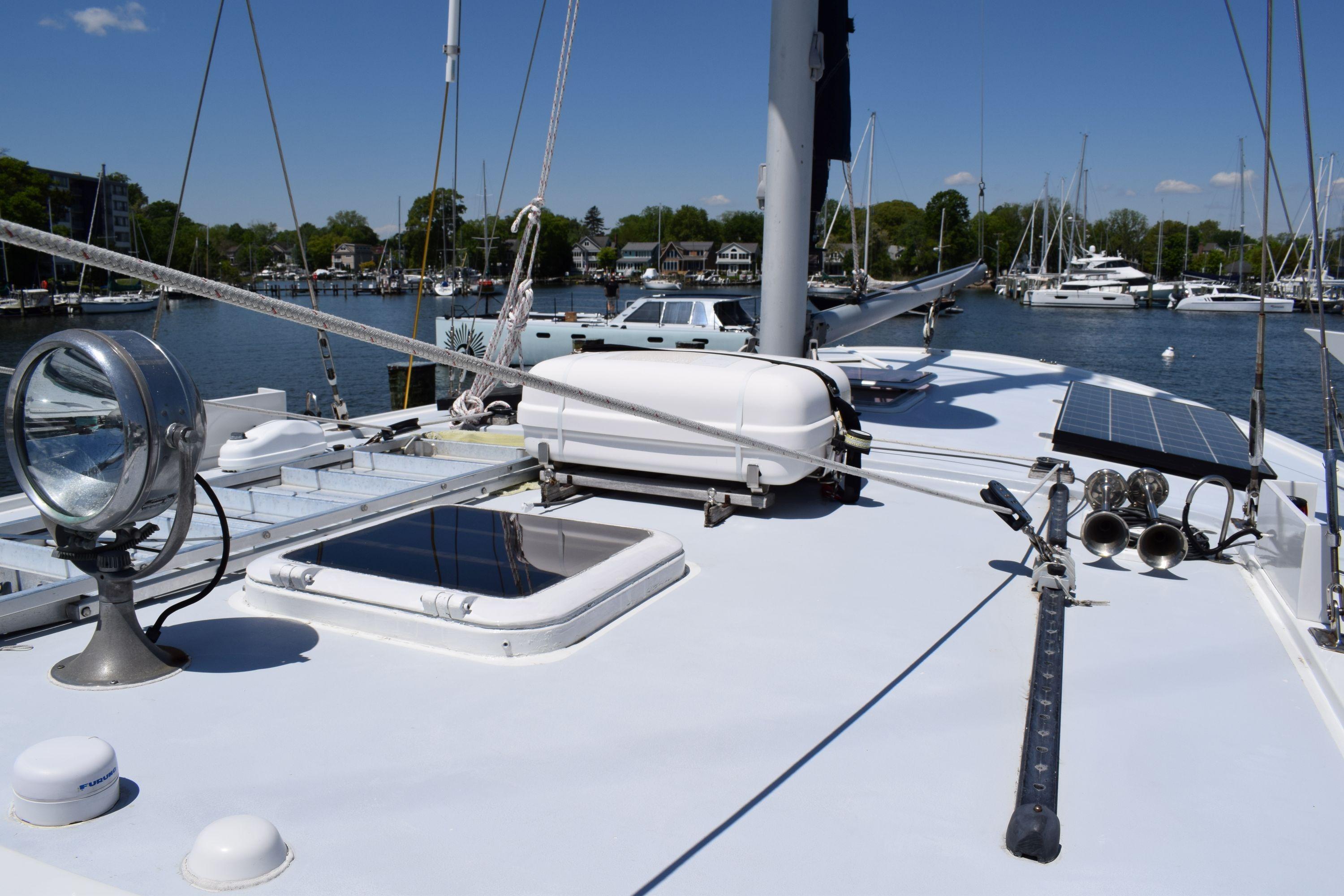 1980 Cheoy Lee 52 Motorsailer deck with solar panels and marina view.