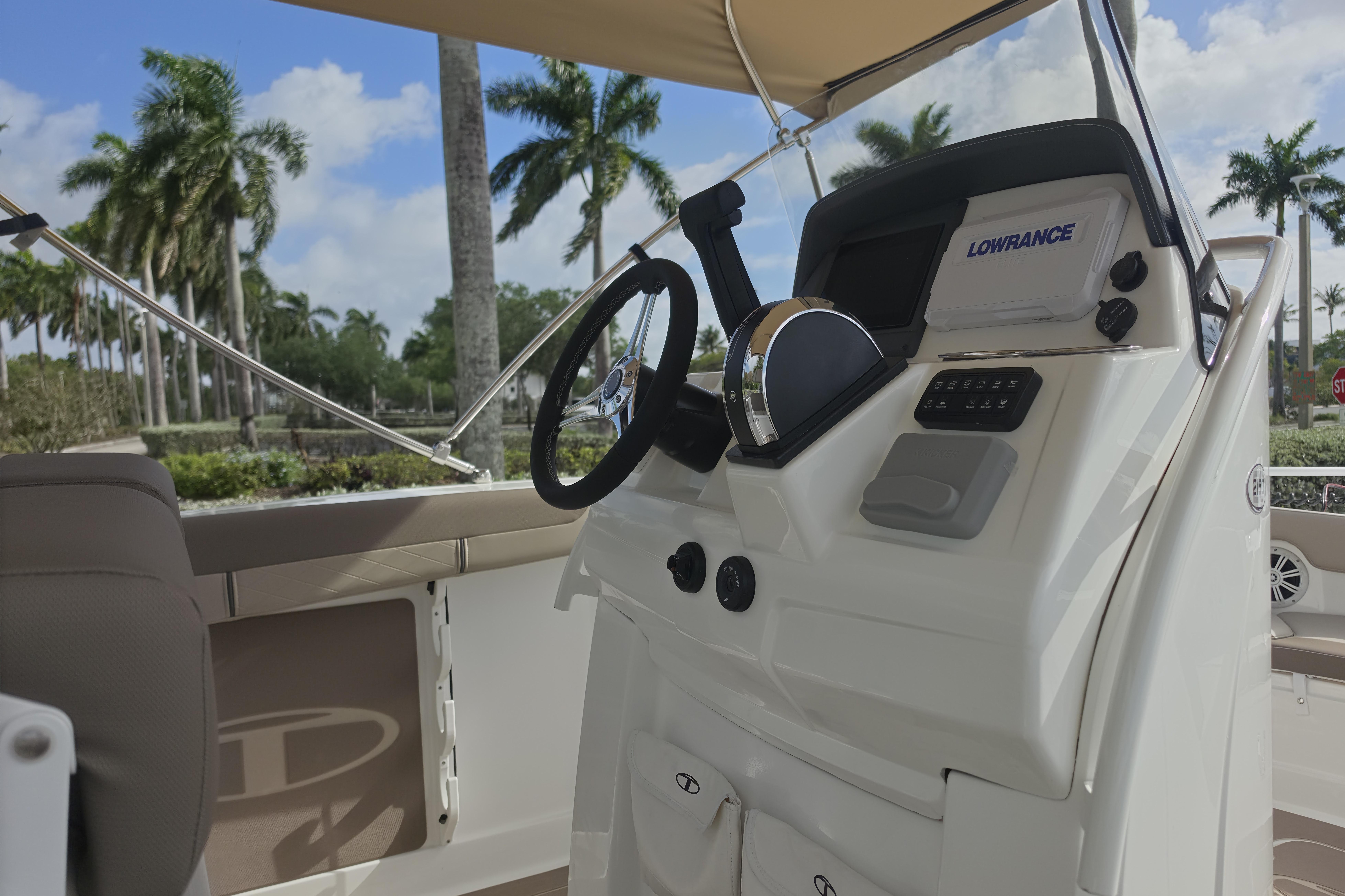 2026 Tahoe 2150 CC boat dashboard with steering wheel and navigation system.