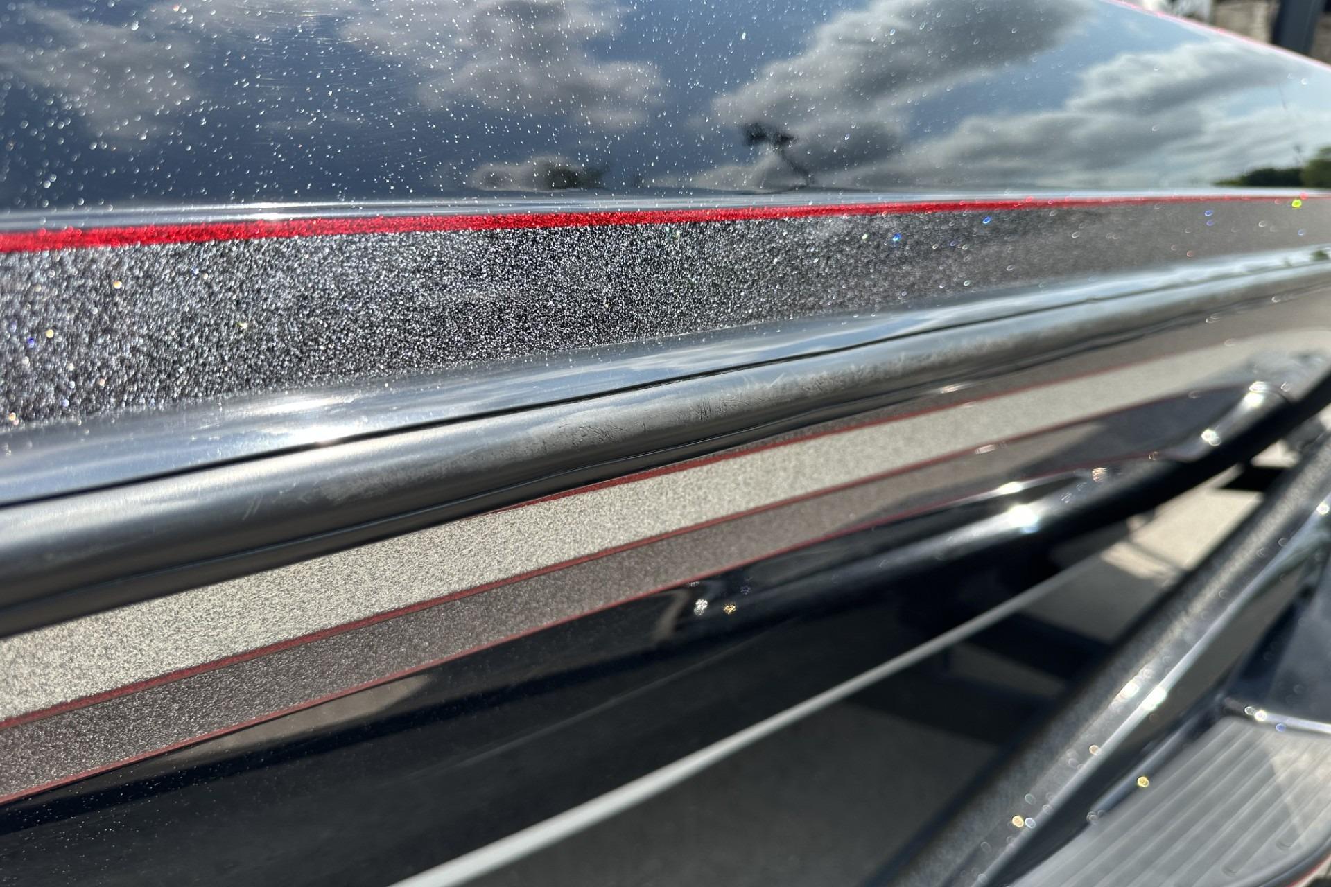 Close-up of 2018 Ranger Z518 boat with metallic finish and red accents under a cloudy sky.