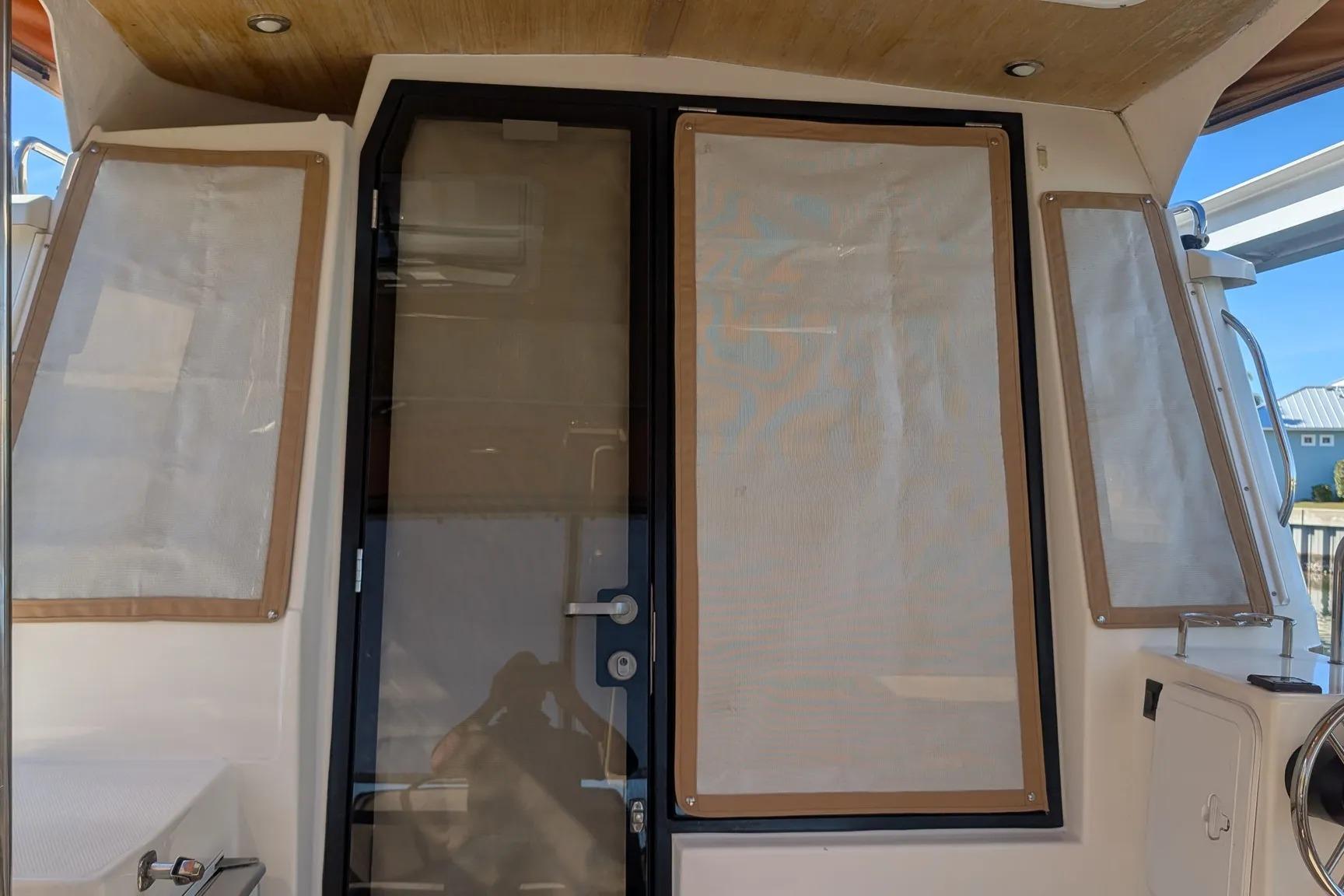 2015 Ranger Tugs R-29 S boat cabin door with covered windows.