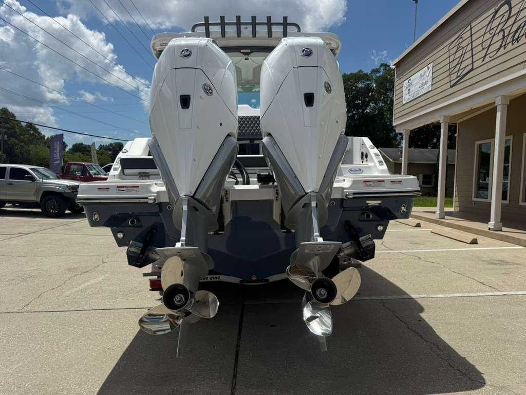 Two powerful outboard engines are mounted on the stern of a Monterey Elite 30 OB boat.