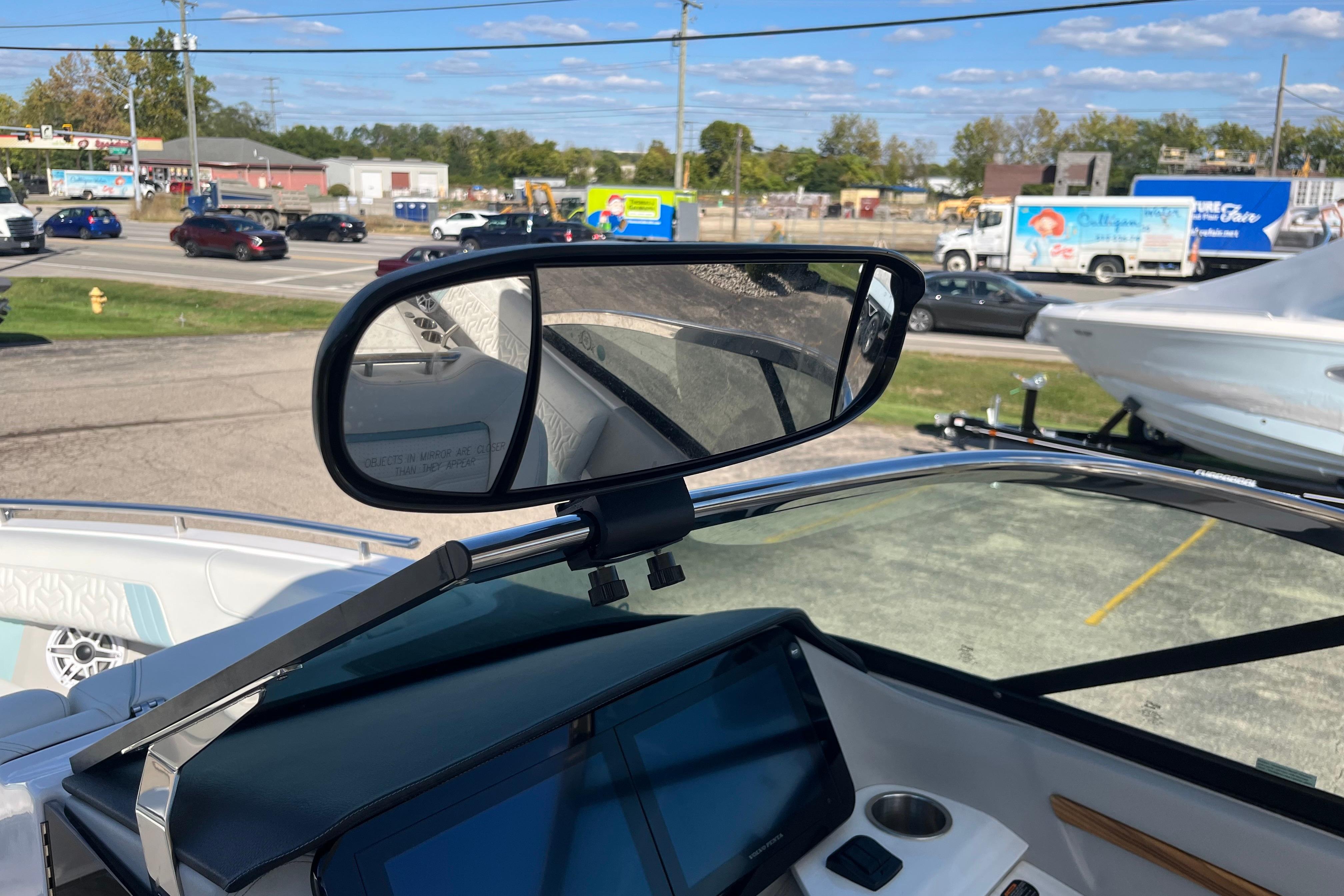2024 Regal LS9 Surf boat dashboard with rearview mirror and digital display.