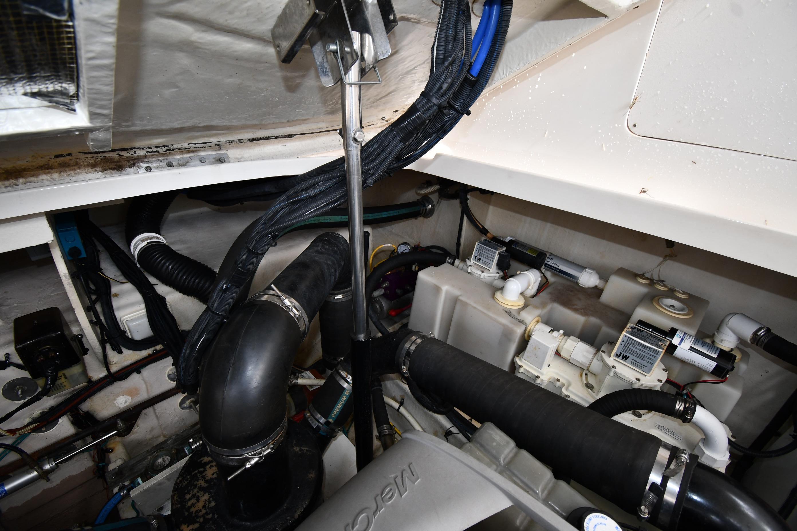 Engine compartment of 2008 Sea Ray Sundancer 350, showcasing hoses and mechanical components.
