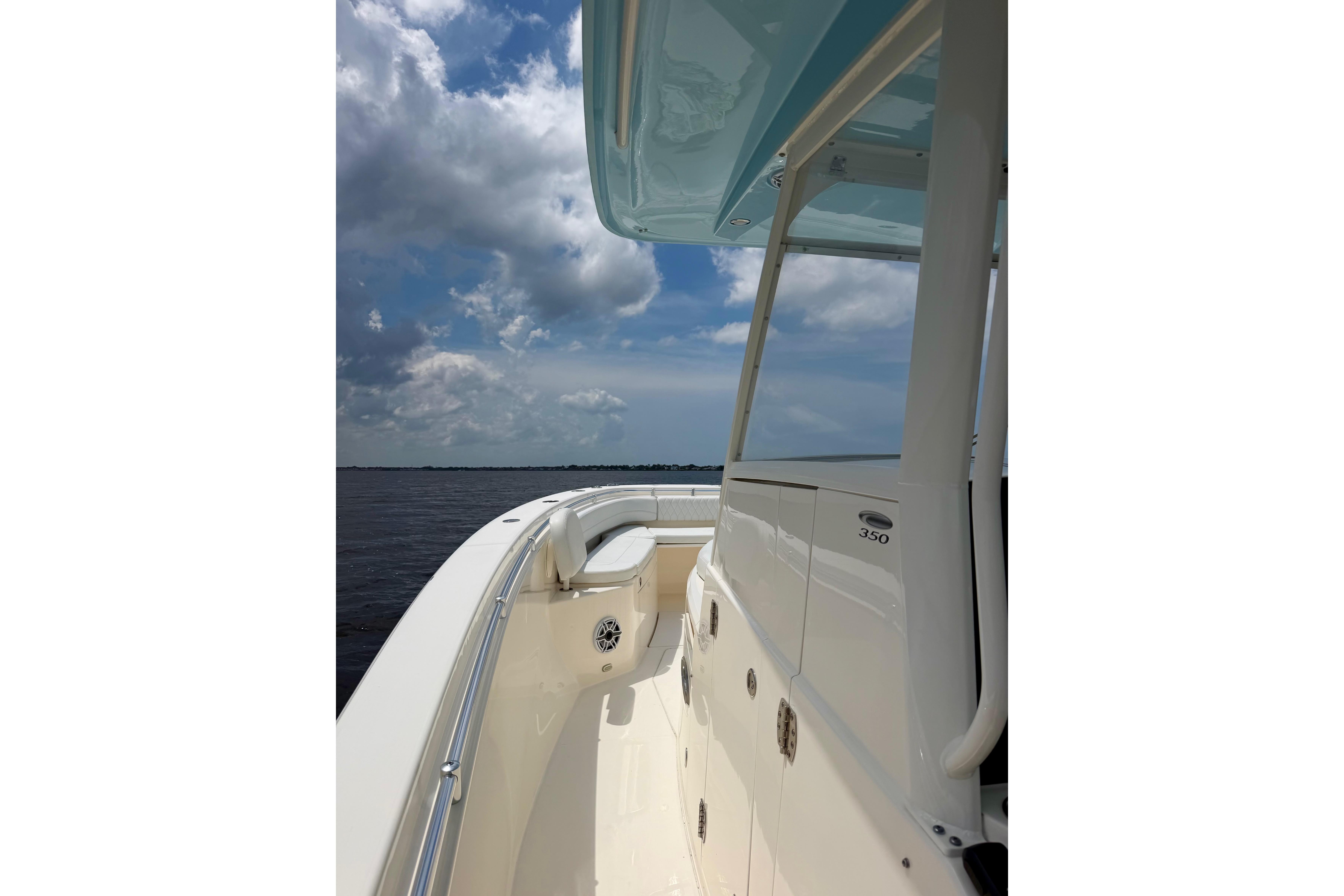 2023 Cobia 350 Center Console boat on open water under cloudy sky.