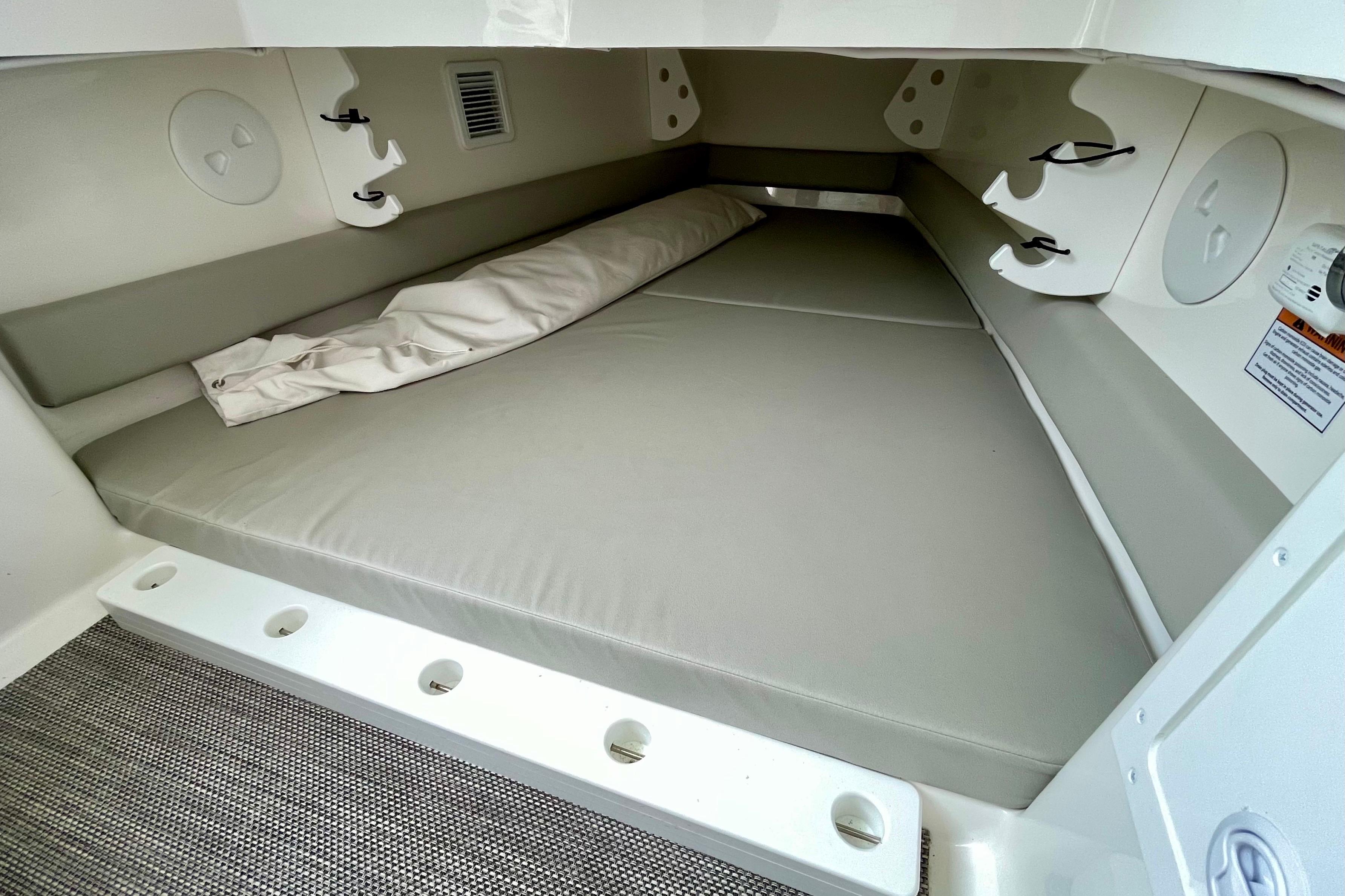 2023 Regulator 34 boat cabin interior with cushioned seating and storage hooks.
