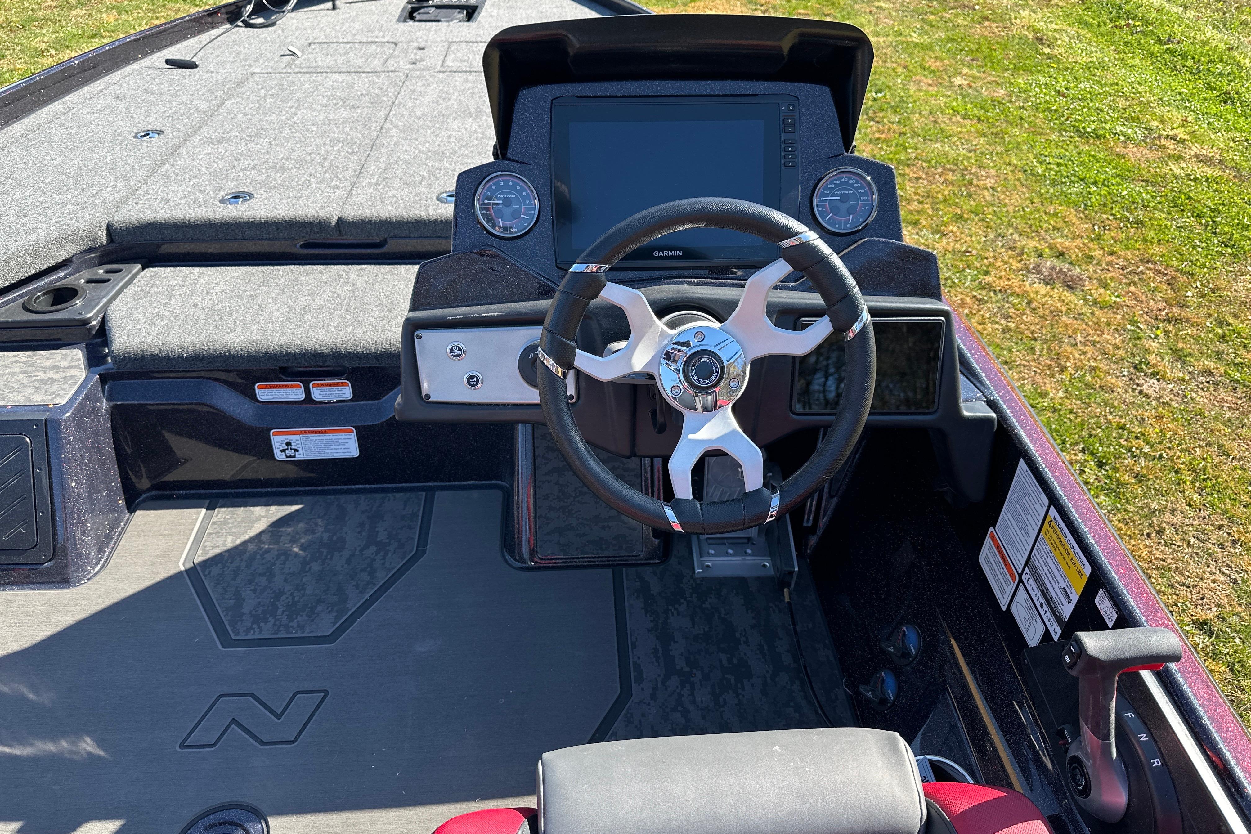 2026 Nitro Z21 XL Pro boat cockpit with steering wheel and digital display.
