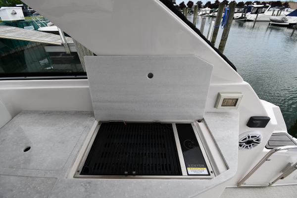 2021 Regal 35 Sport Coupe boat grill area with marina view.
