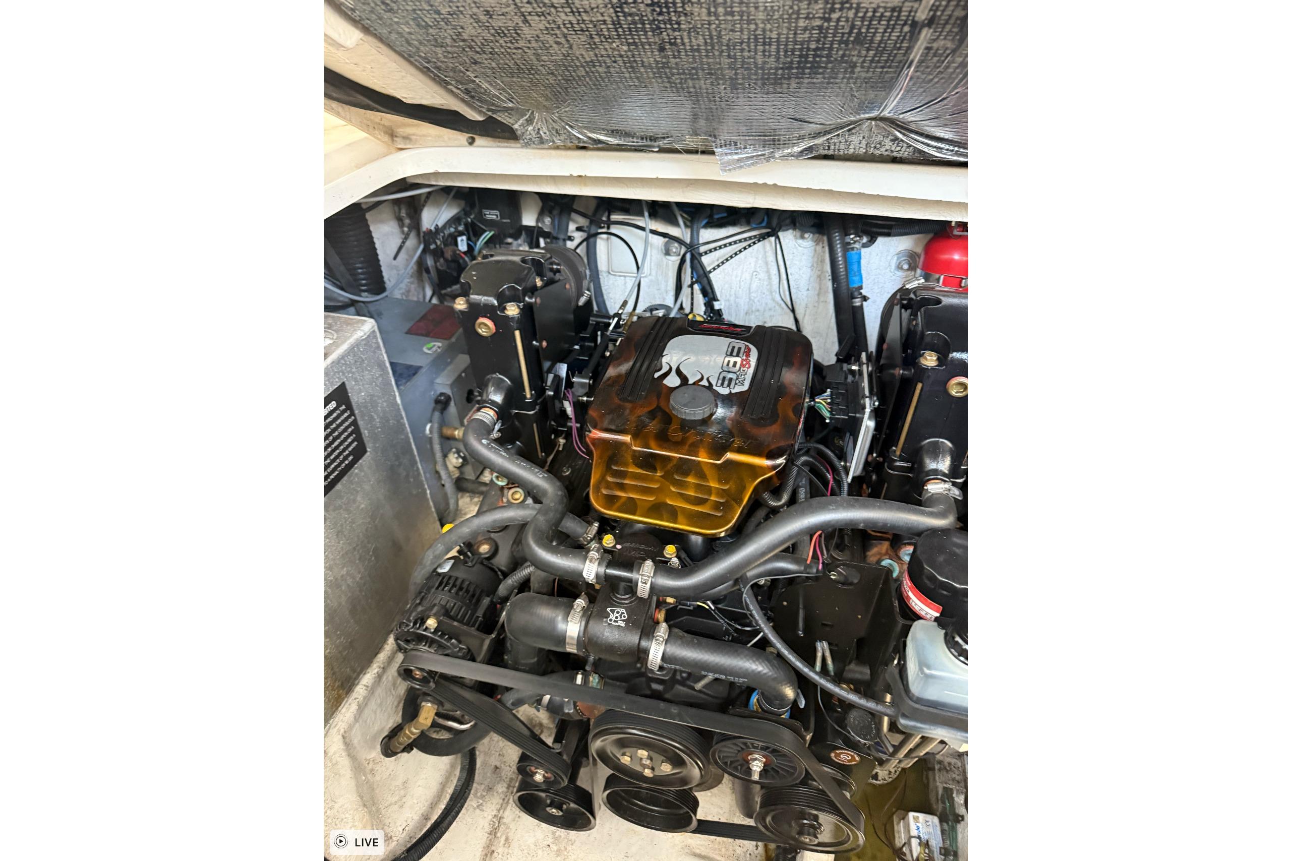 Engine compartment of a 2006 Sea Ray 300 Sundancer boat, showcasing mechanical components.
