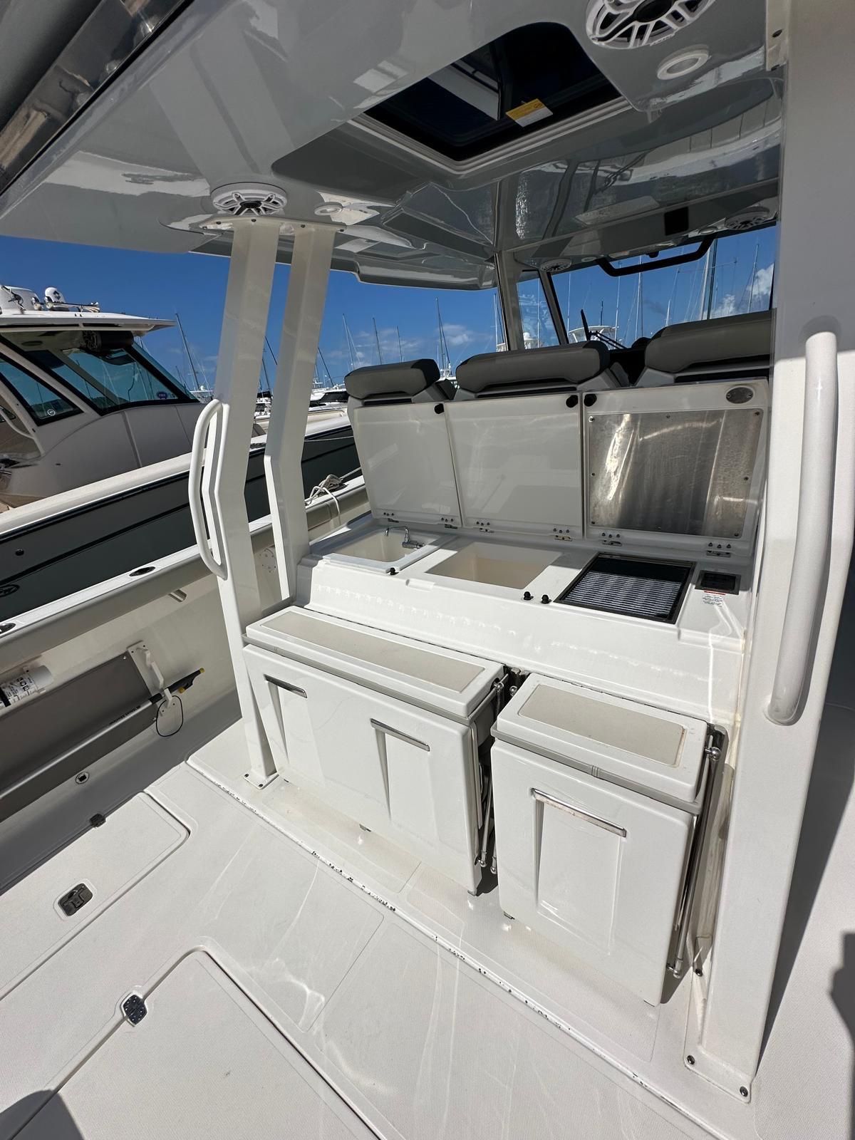 2023 Pursuit S 358 Sport boat interior with seating and storage compartments.